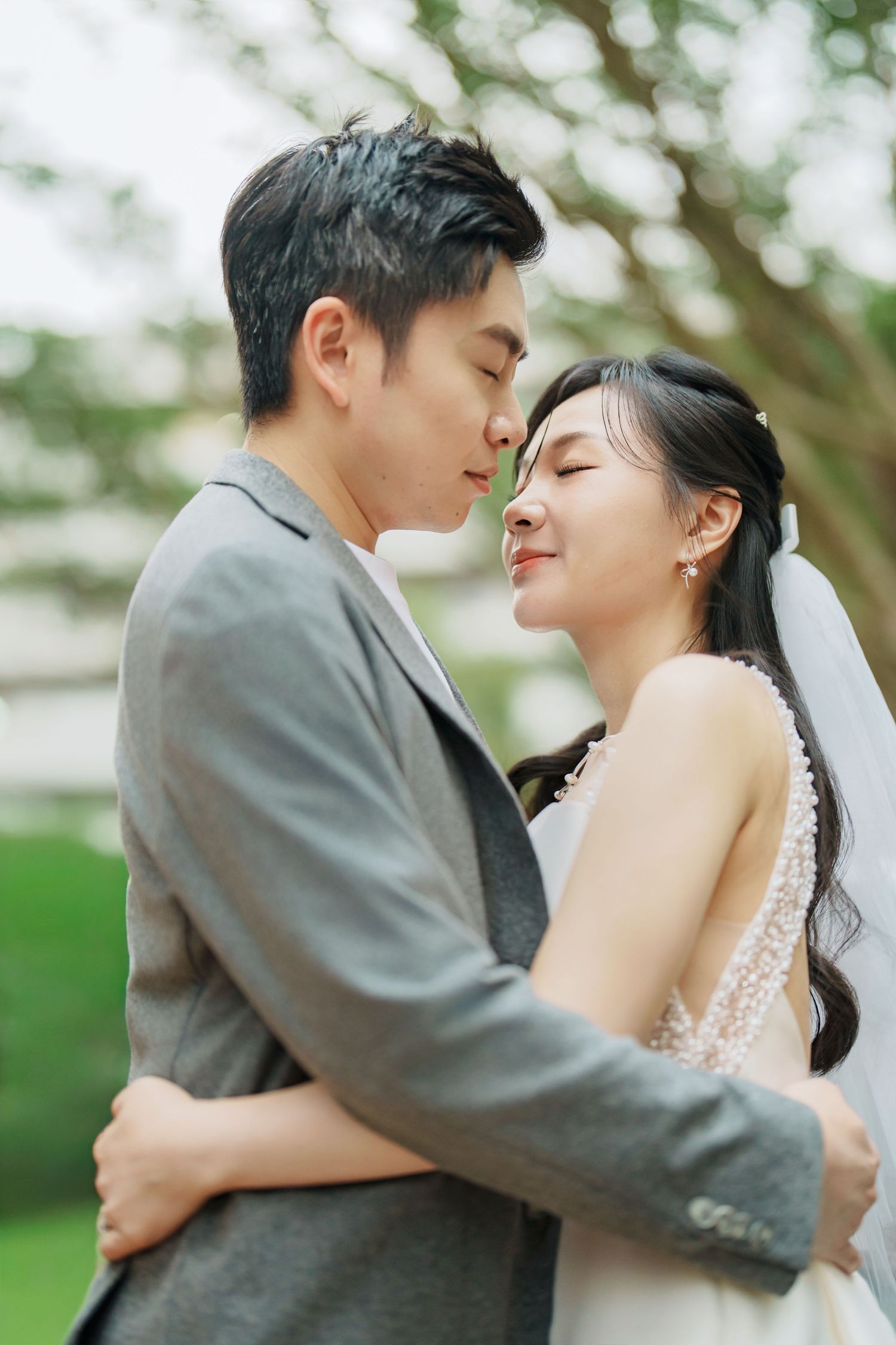 A romantic wedding couple shares tender moments in a series of intimate outdoor portrait photographs.