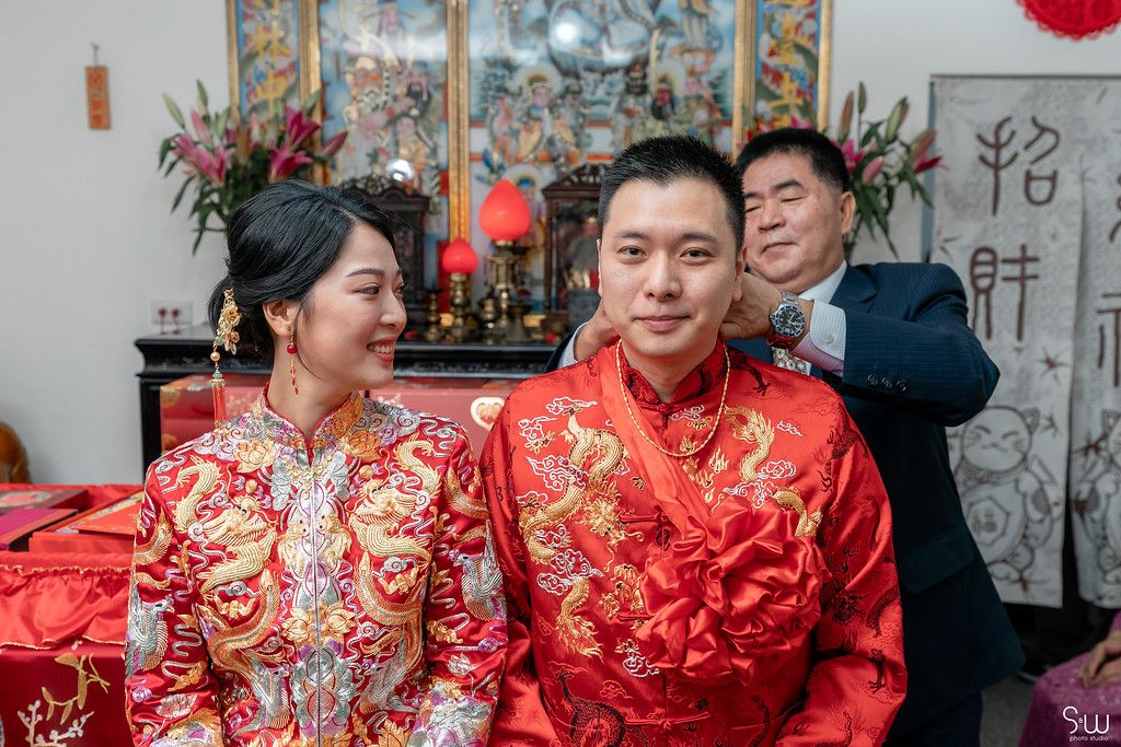 Candid moment during Chinese wedding celebration with traditional decorations.