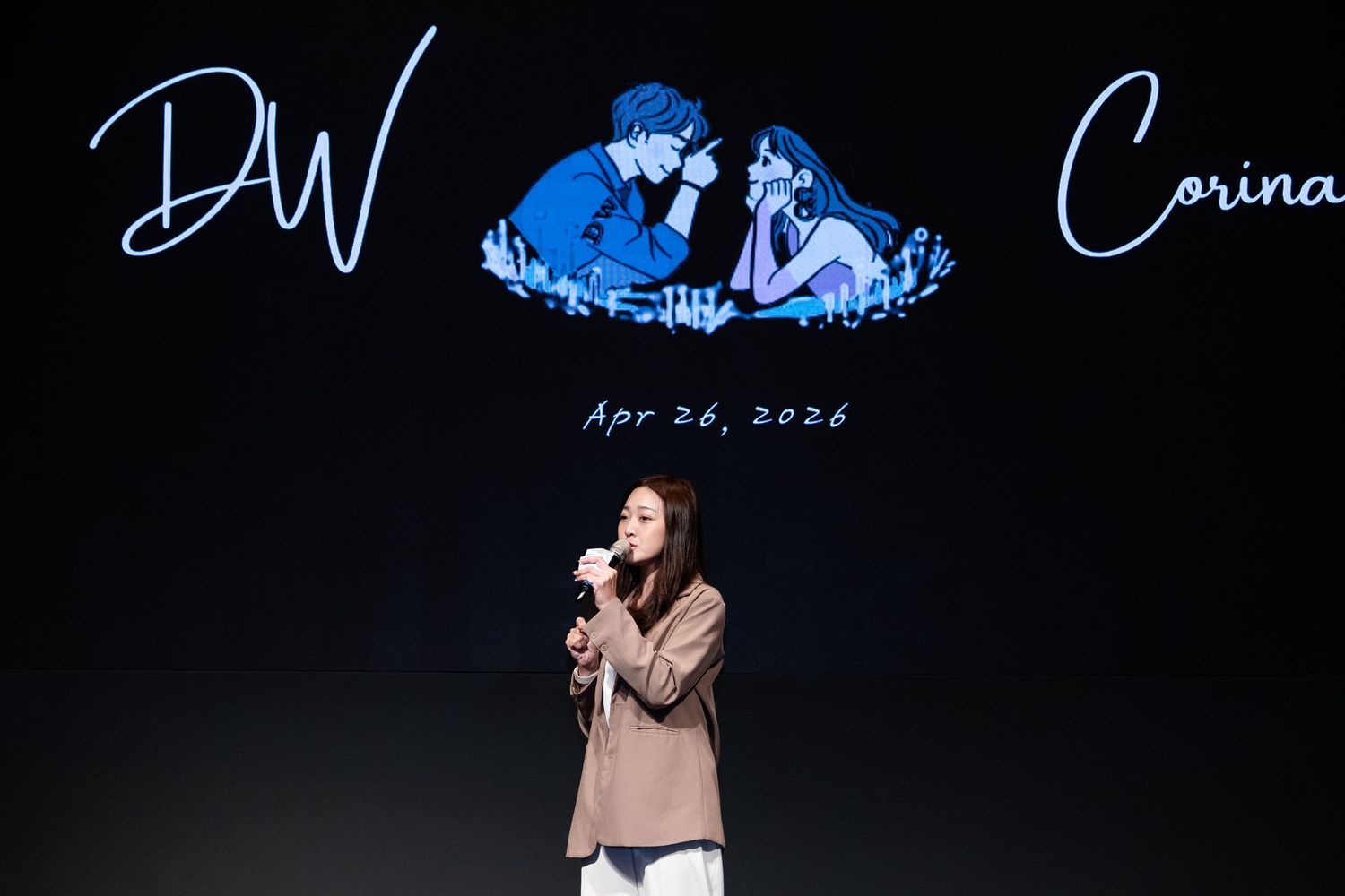 Woman singing on stage at wedding event for DW and Corina, dated Apr 26, 2026, with romantic blue illustration backdrop.