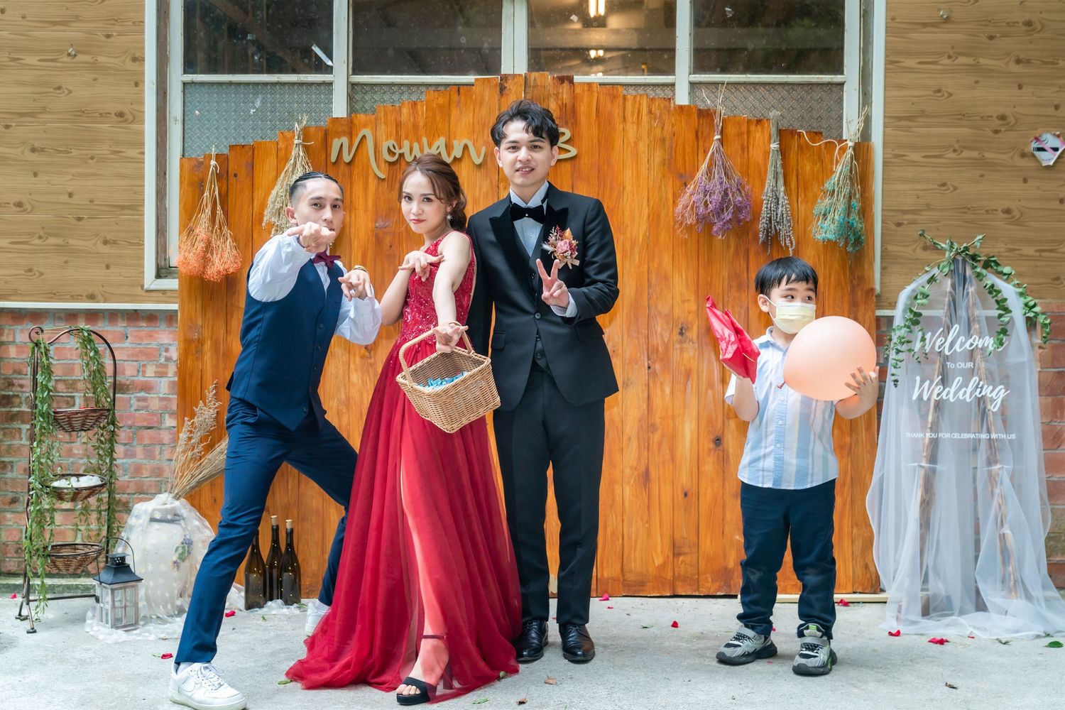 A playful group photo with casual and formal attire against an orange backdrop.
