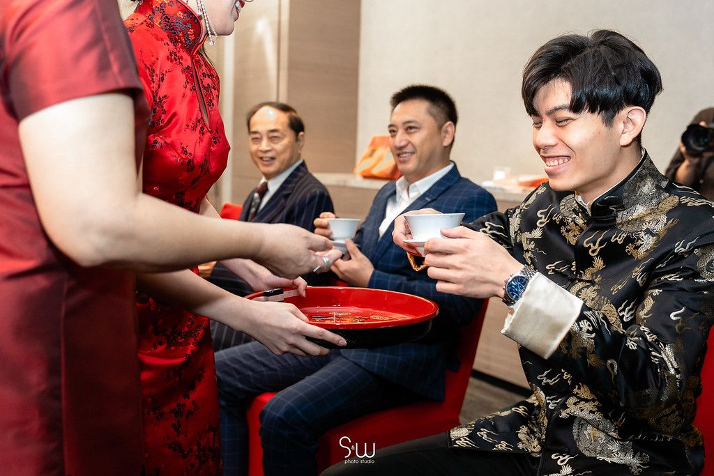 Tea is being served to guests during a traditional Chinese wedding ceremony.