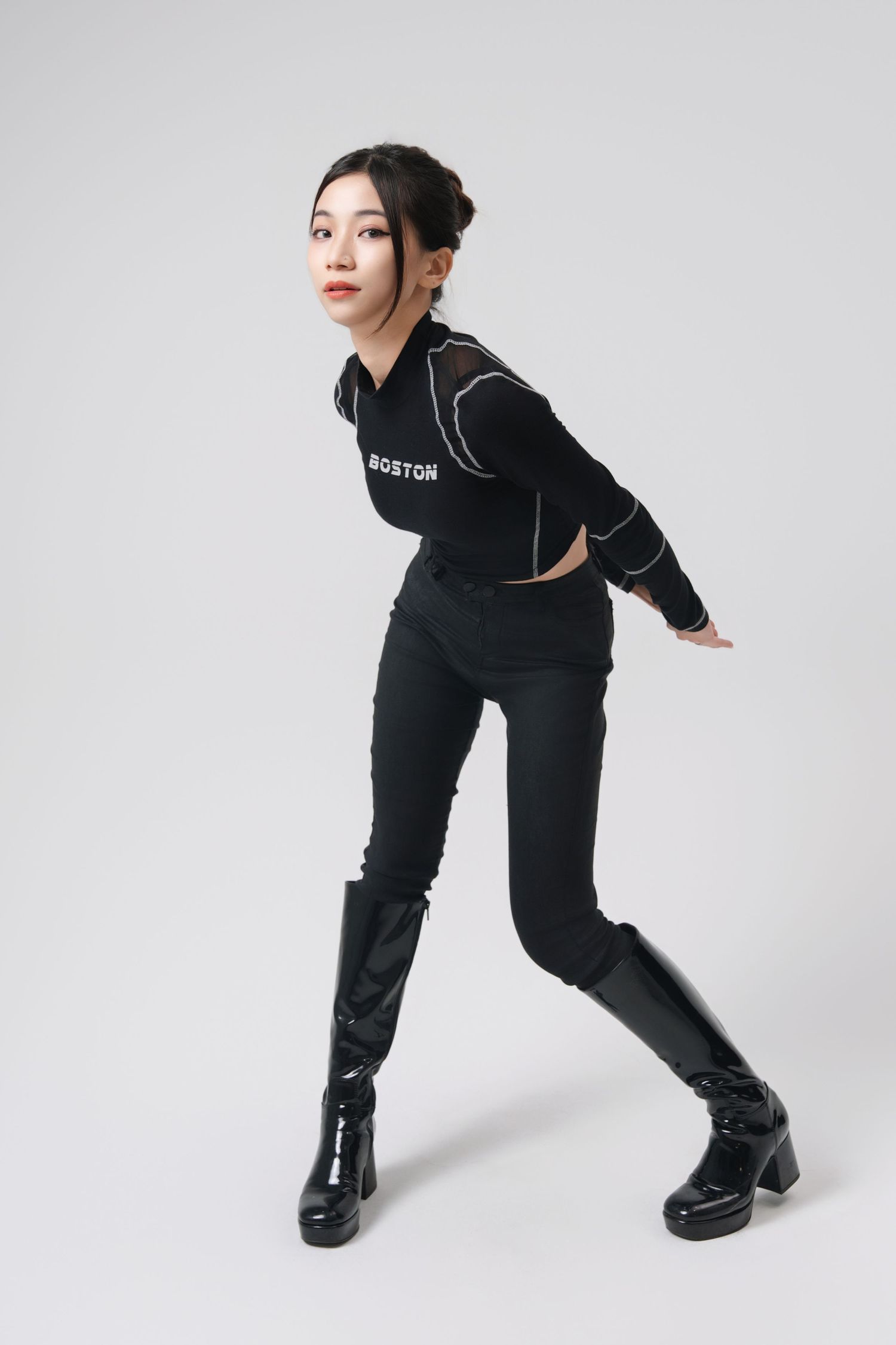 Athletic figure in black streetwear ensemble poses dynamically against white background in four sequential shots.