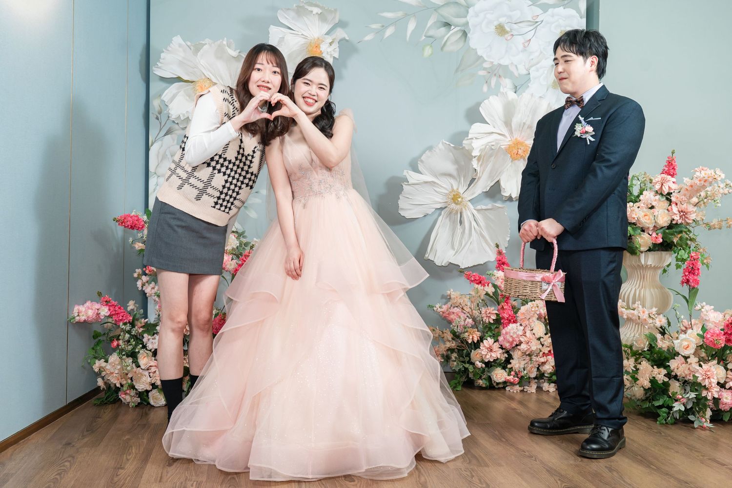A romantic wedding photo collage showing couples in elegant attire posing against a floral backdrop with pink roses.