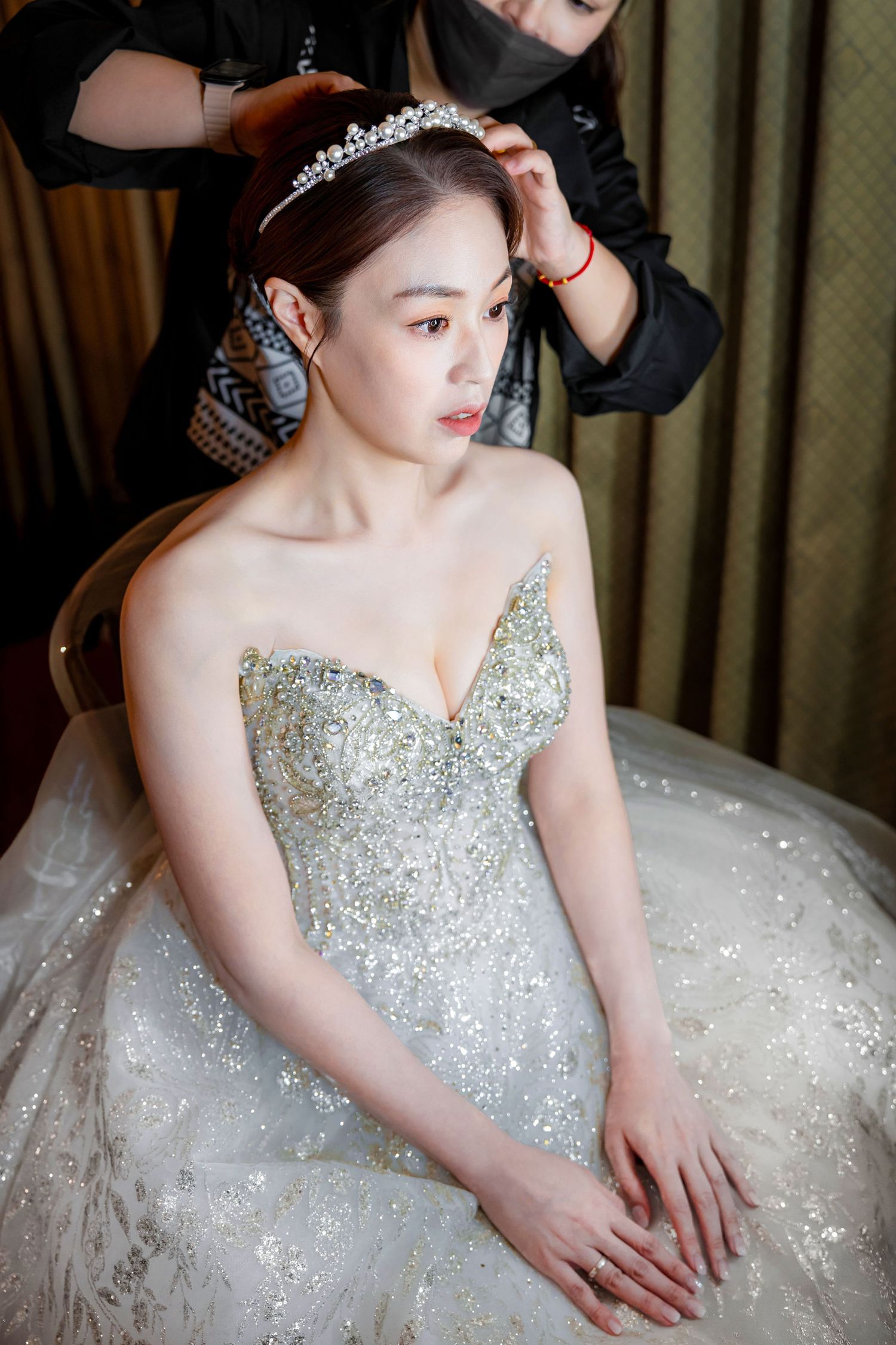A bride in a sparkling white and silver beaded wedding gown sits elegantly in a series of connected photos.