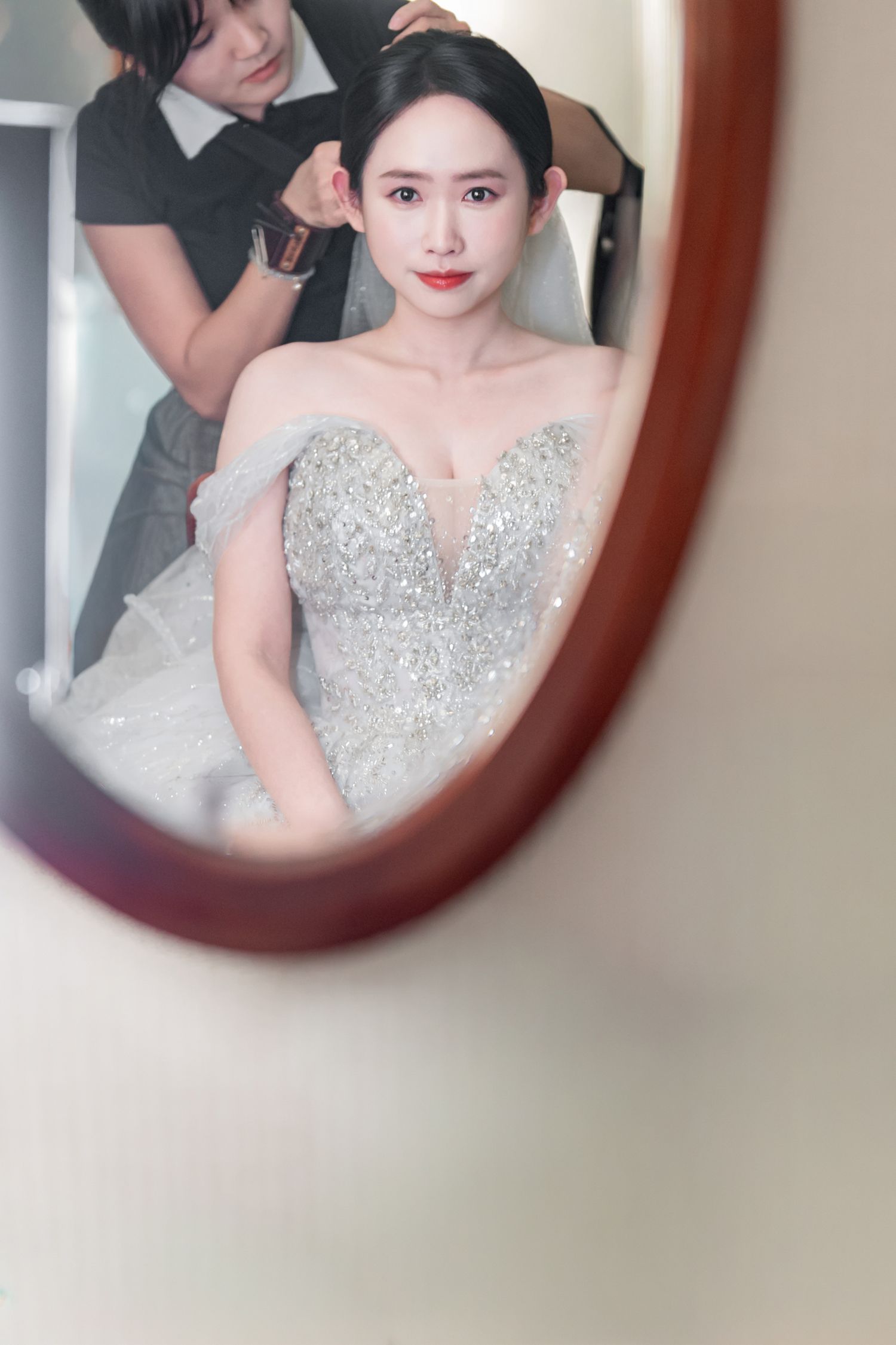 A series of mirror reflections showing a person wearing a sparkling silver sequined formal gown.