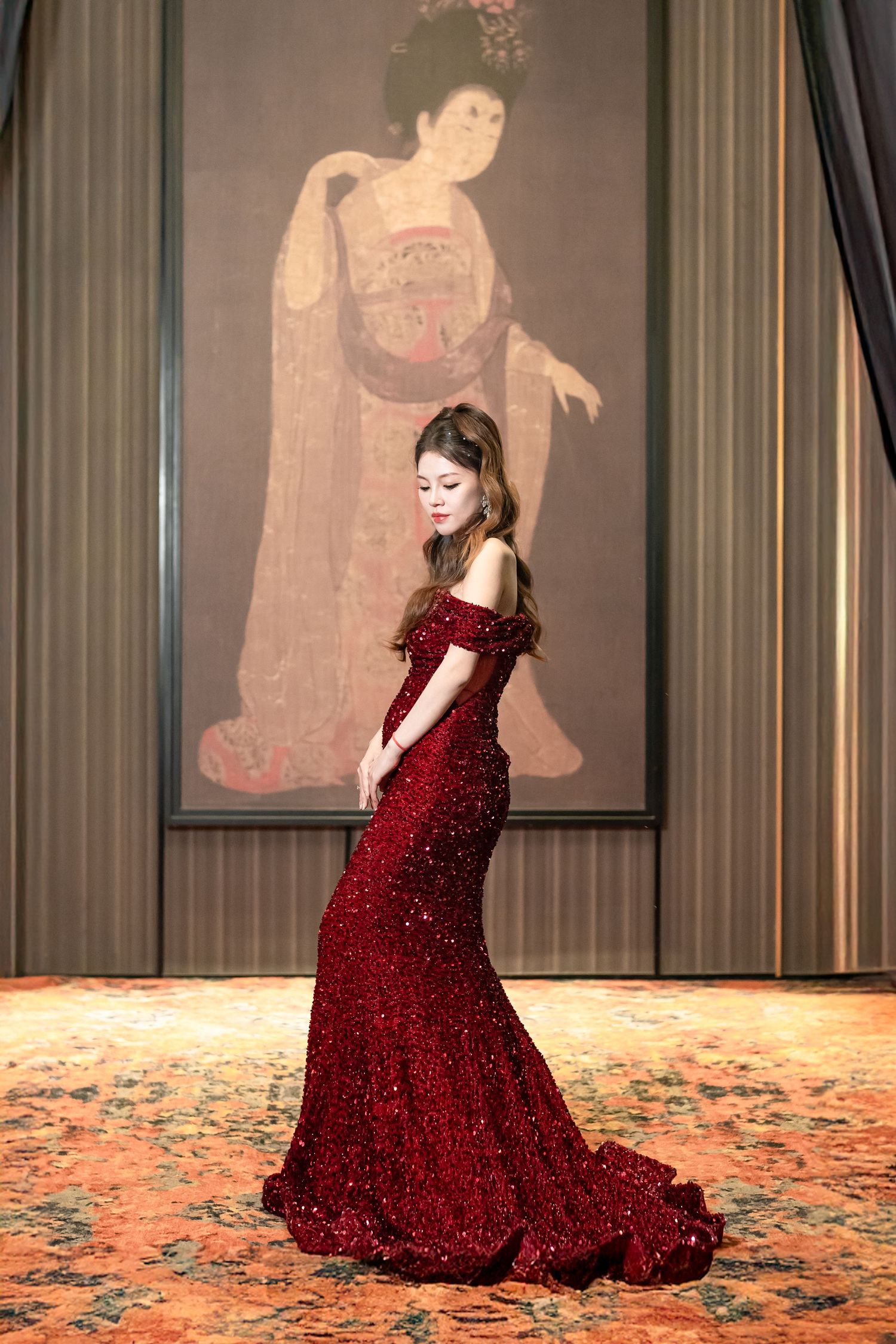A sequence of photos showing a person in a sparkling red ballgown twirling elegantly across a patterned carpet.