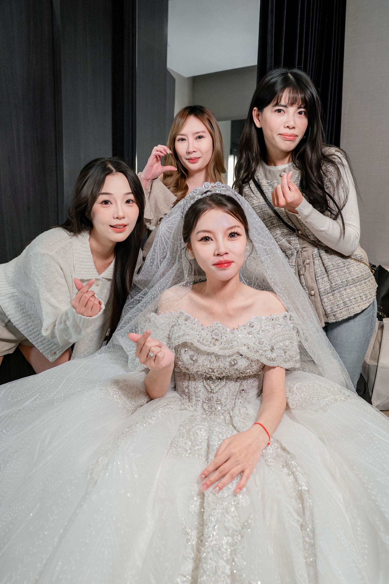 A bride in a sparkling white ball gown with off-shoulder design poses in multiple angles showing elegant details.