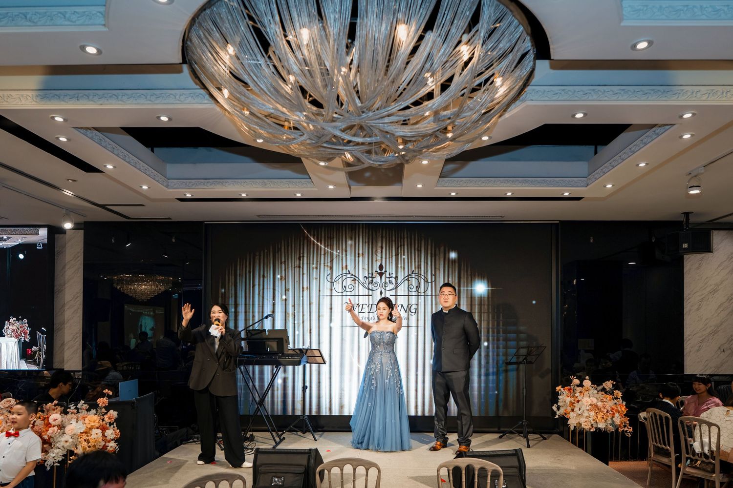 Modern restaurant interior with elegant crystal chandeliers and contemporary decor featuring warm lighting and sleek design.