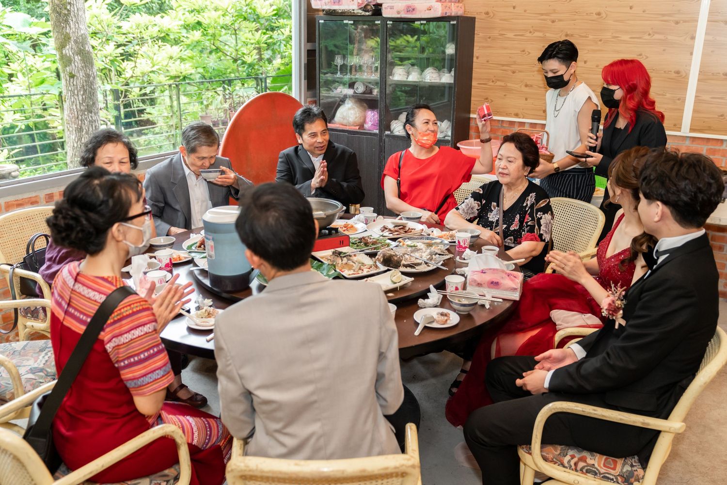 Wedding reception gathering with guests dining at outdoor venue.