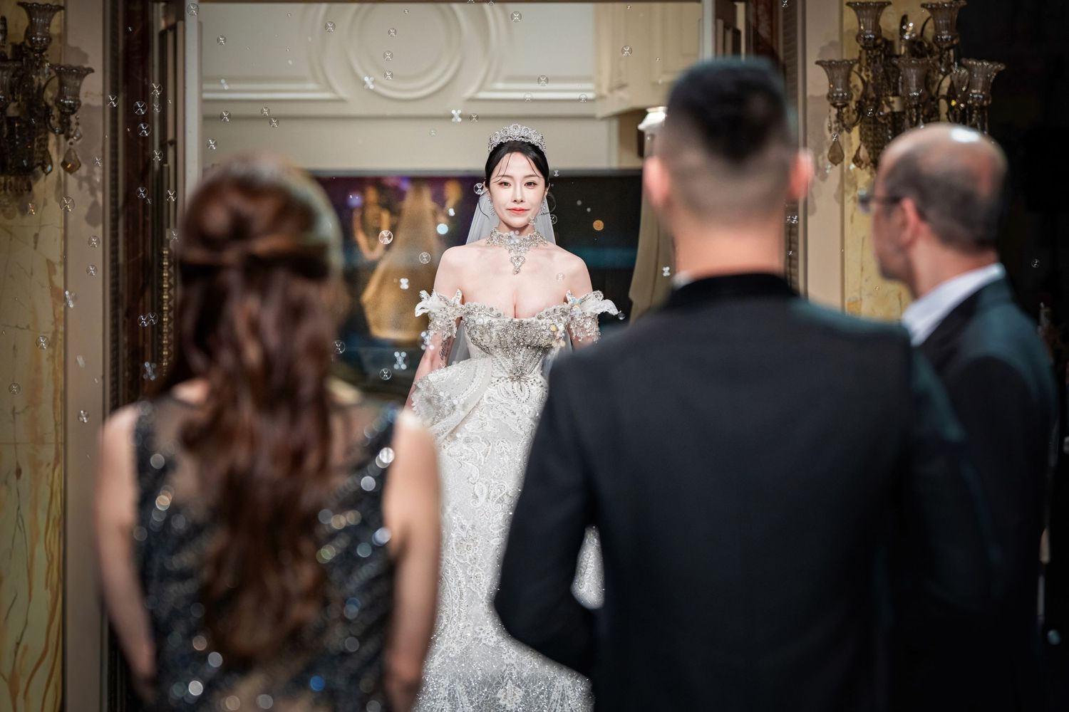 Wedding fashion models showcase elegant bridal gowns and formal attire on a luxury runway during a bridal show.