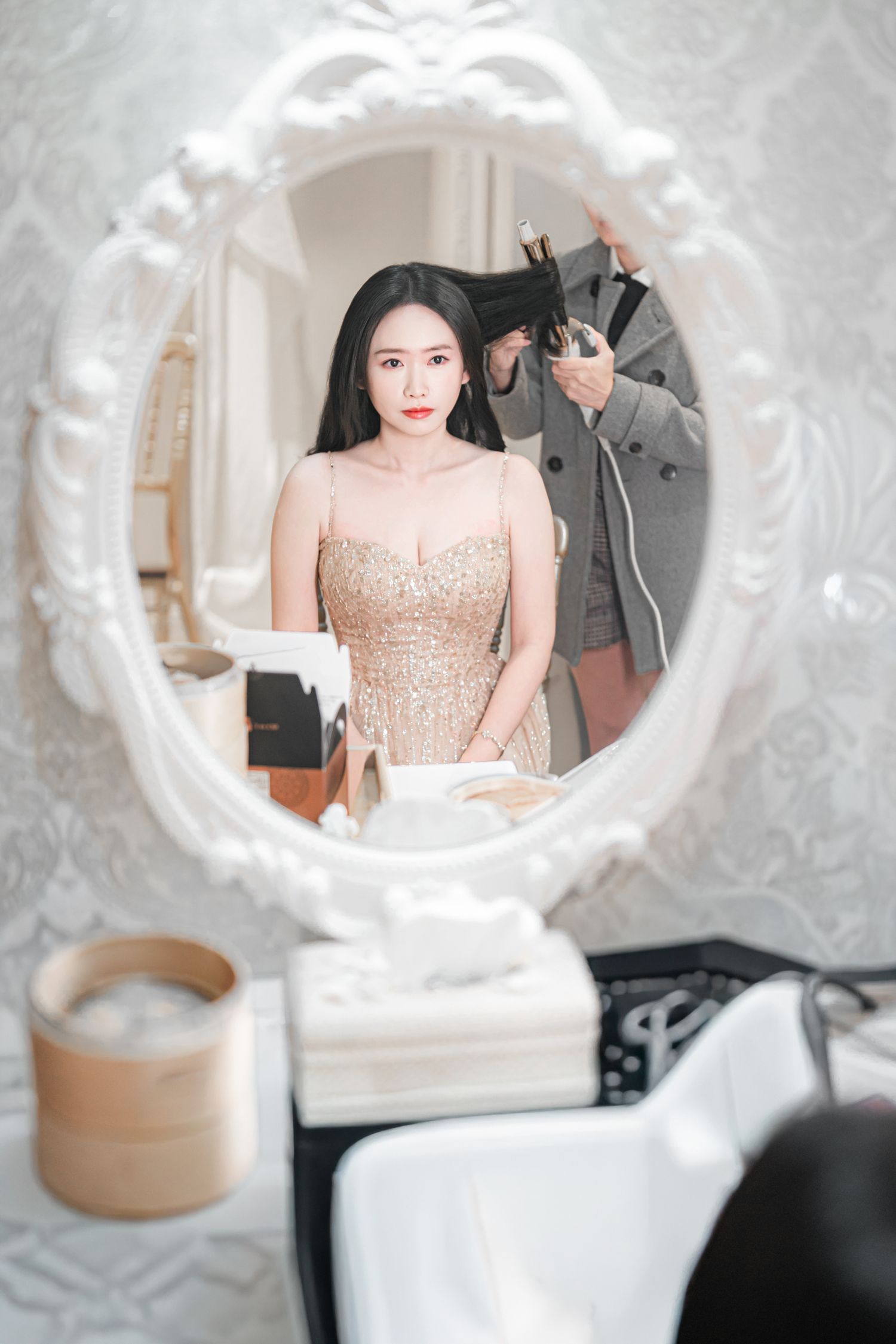 Multiple shots of a figure in a sequined dress viewed through decorative white circular frames.