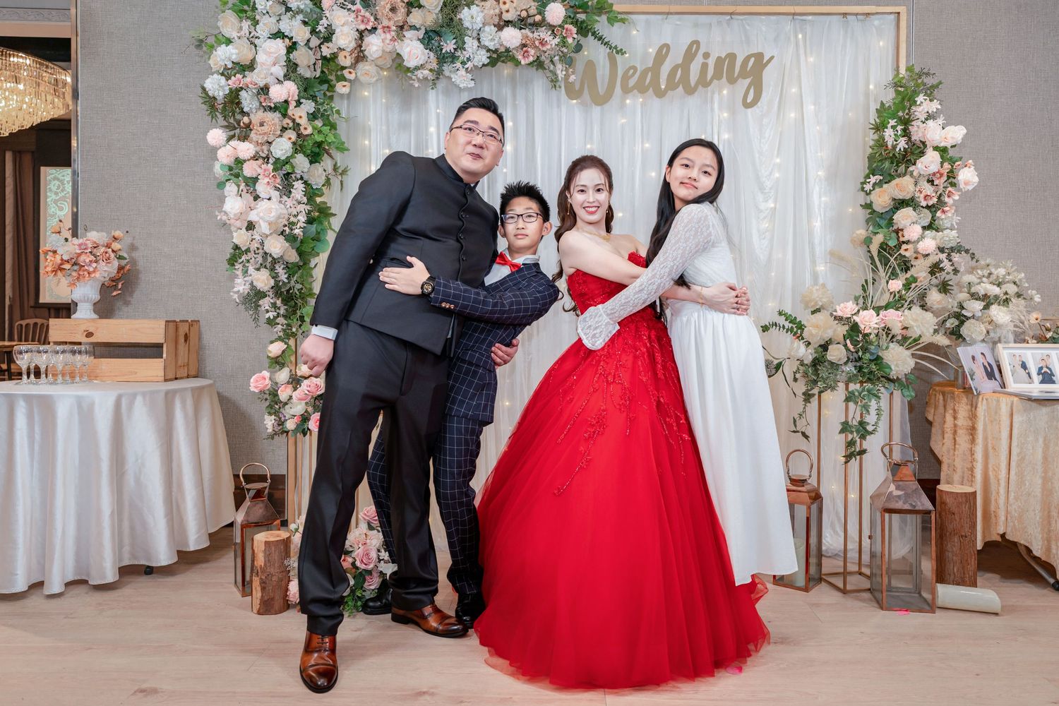 Wedding photo studio setup with elegant floral decorations and red and white color scheme.