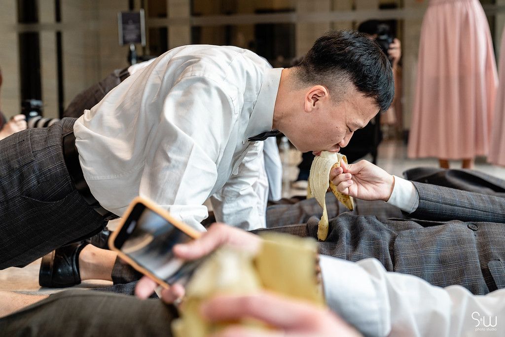 Wedding party members engage in playful traditional games during celebration.