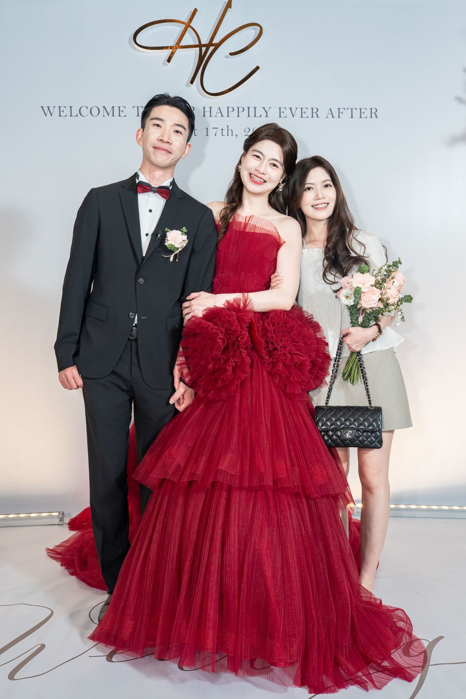 A grand celebration scene featuring formal attire with a stunning red tulle ball gown as the centerpiece at an elegant event.