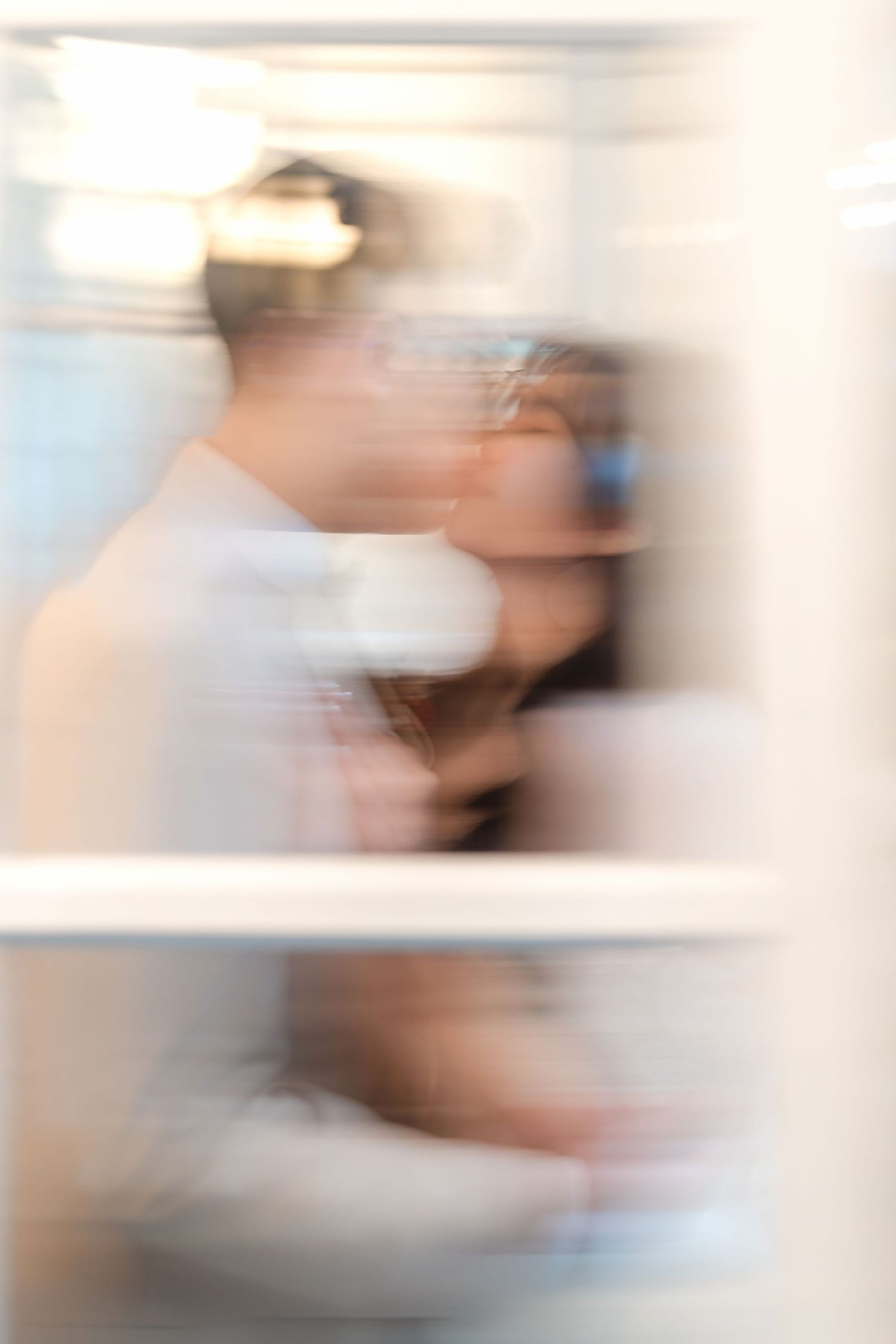 Abstract blurred motion photograph in muted beige and brown tones creating an ethereal effect.