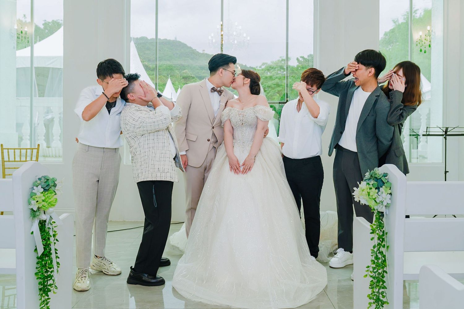 Panoramic collage of wedding moments showing dancing, celebration and joyful interactions in an elegant white venue.