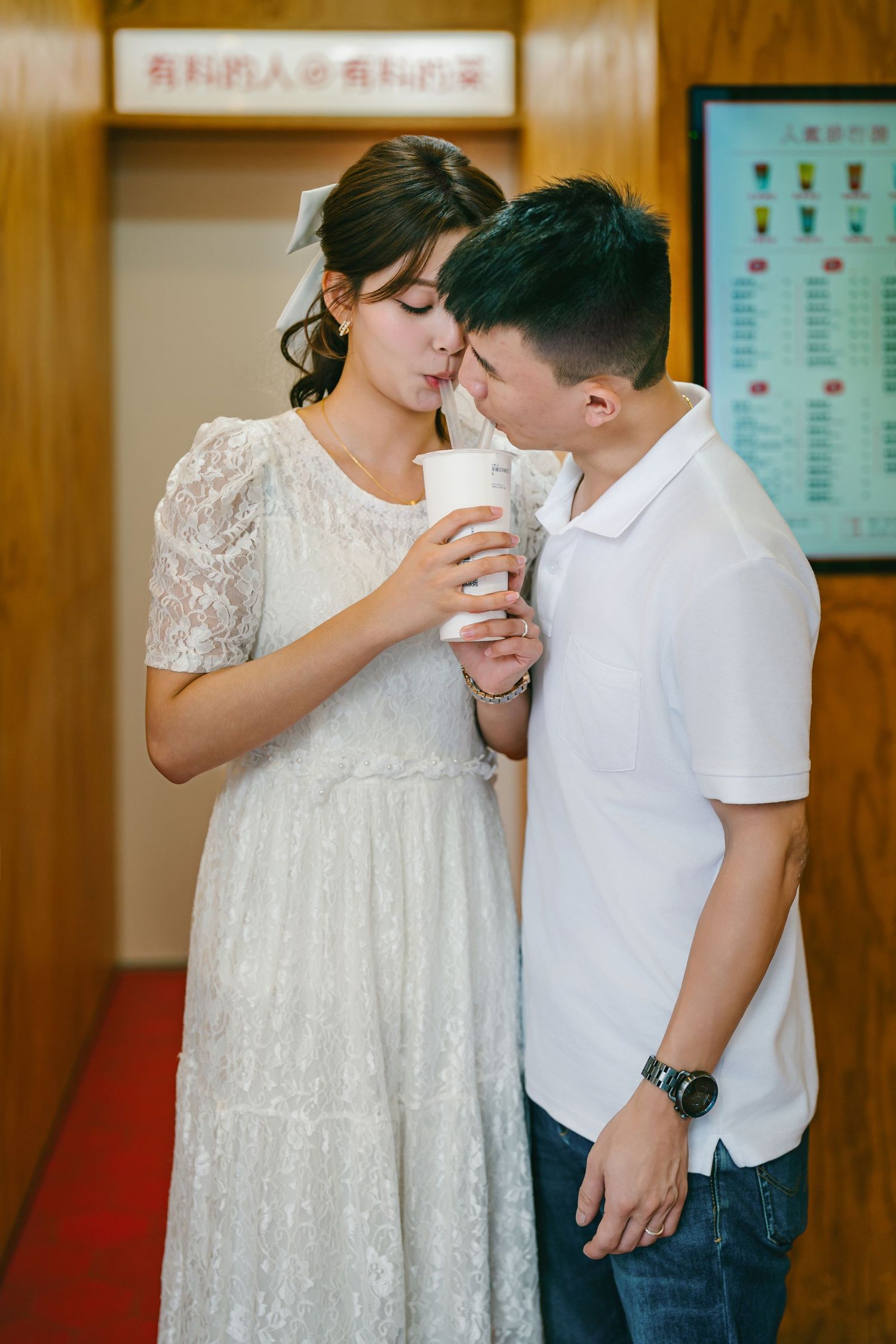 A couple in white sharing an intimate moment in a sequence of four similar romantic poses.