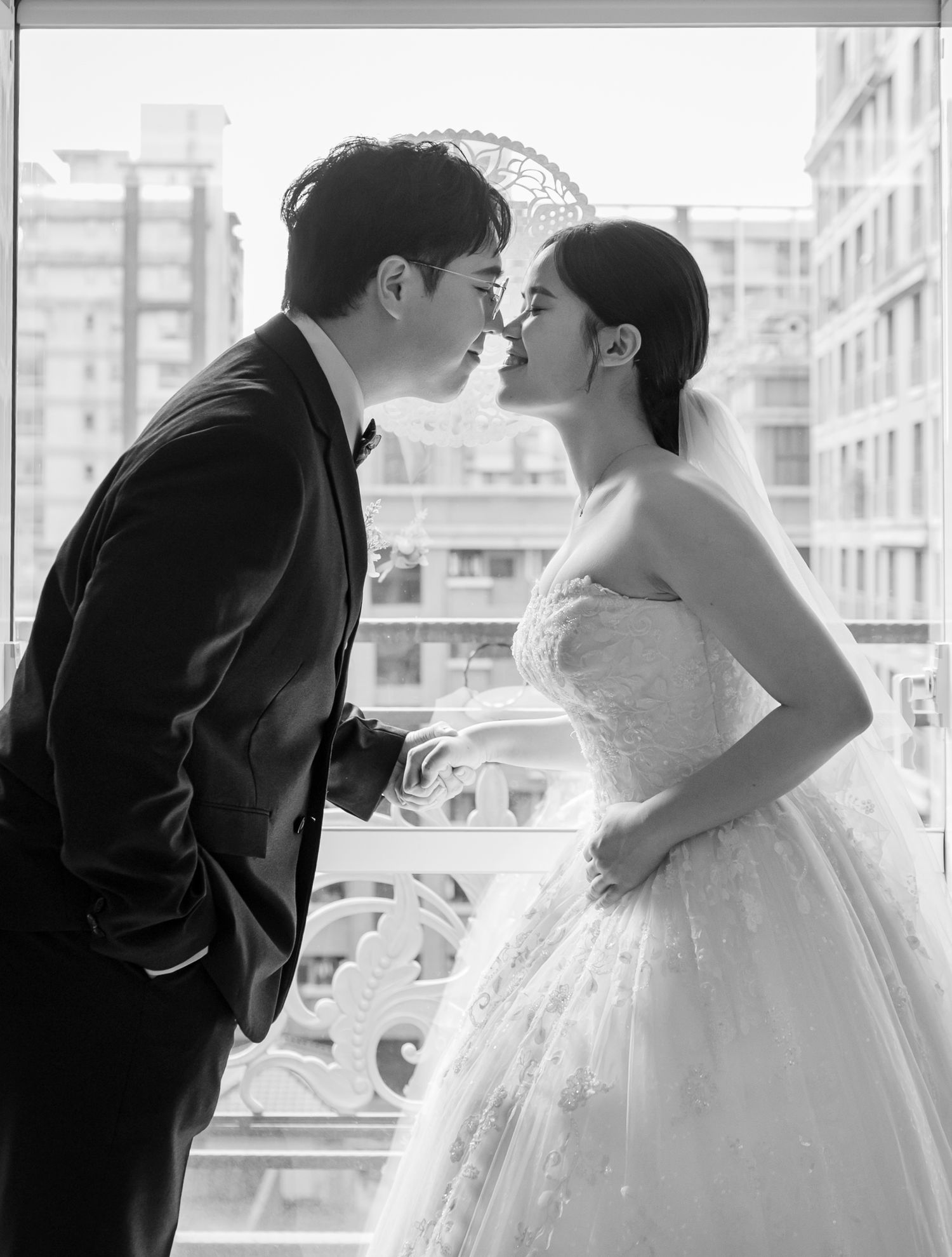 A romantic black and white wedding photo sequence showing a couple sharing tender kisses in formal attire.