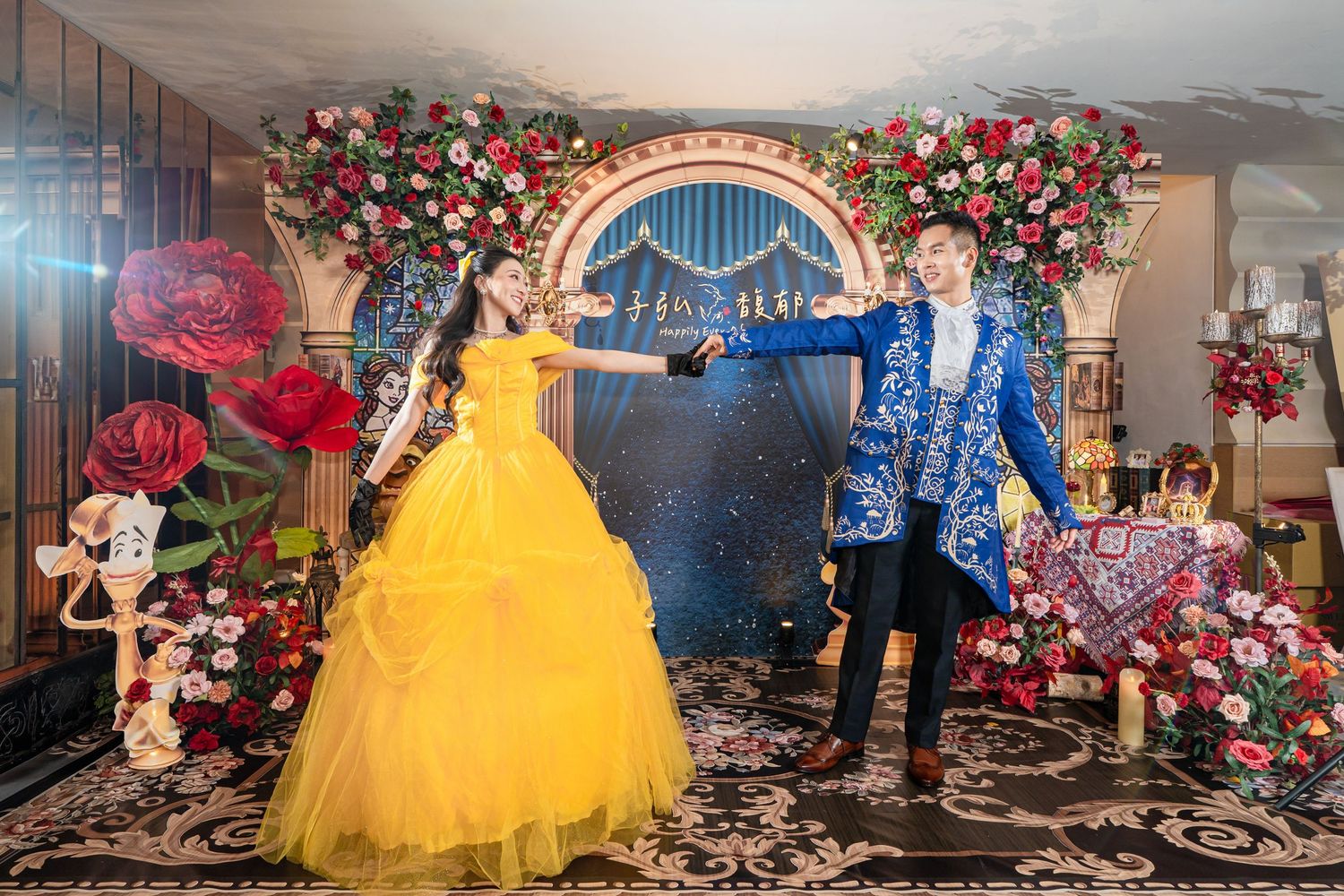 Couple in Beauty and the Beast costumes pose at an elegant floral themed quinceañera backdrop.
