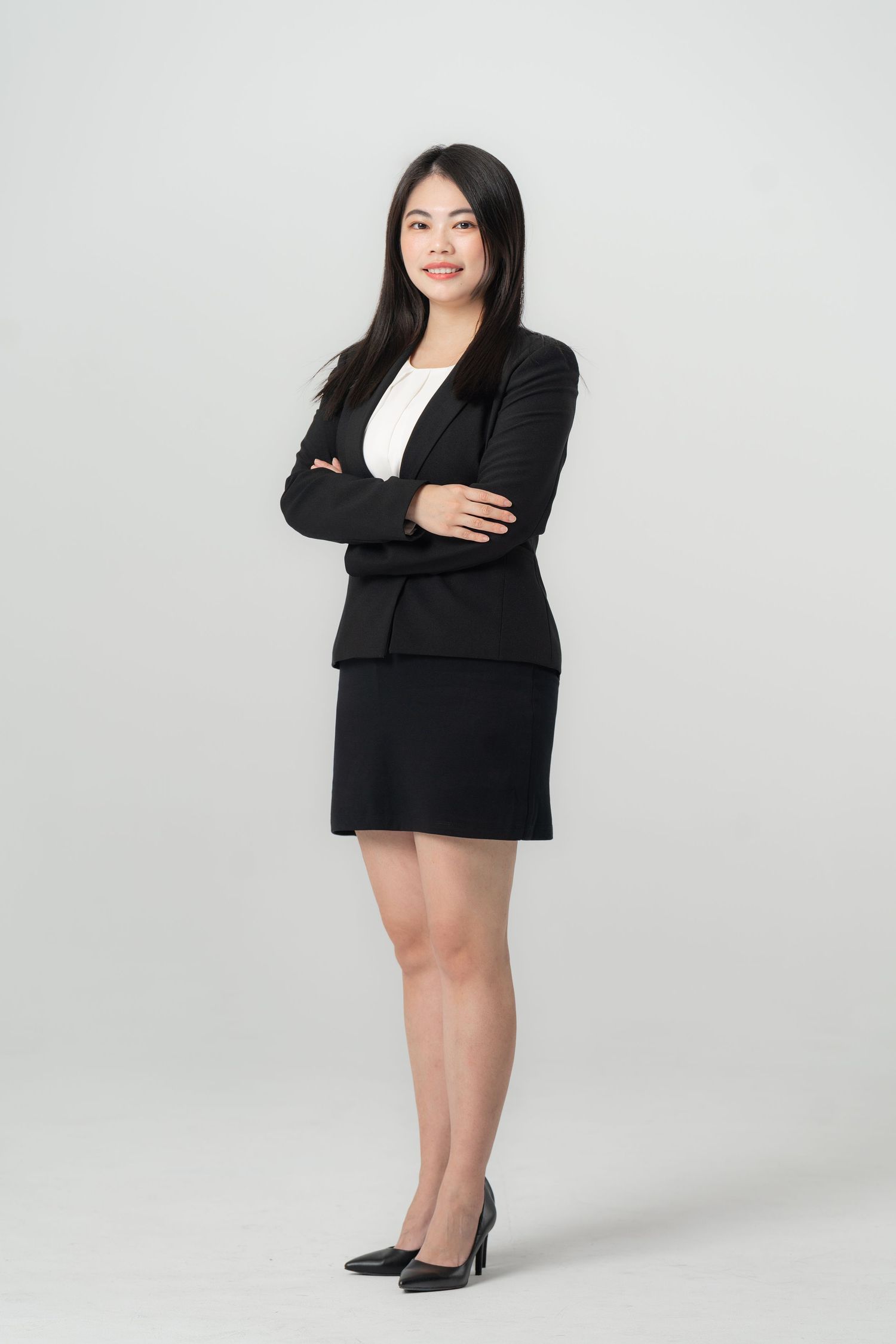 Professional business portrait series showing confident poses in black blazer and skirt against white studio background.