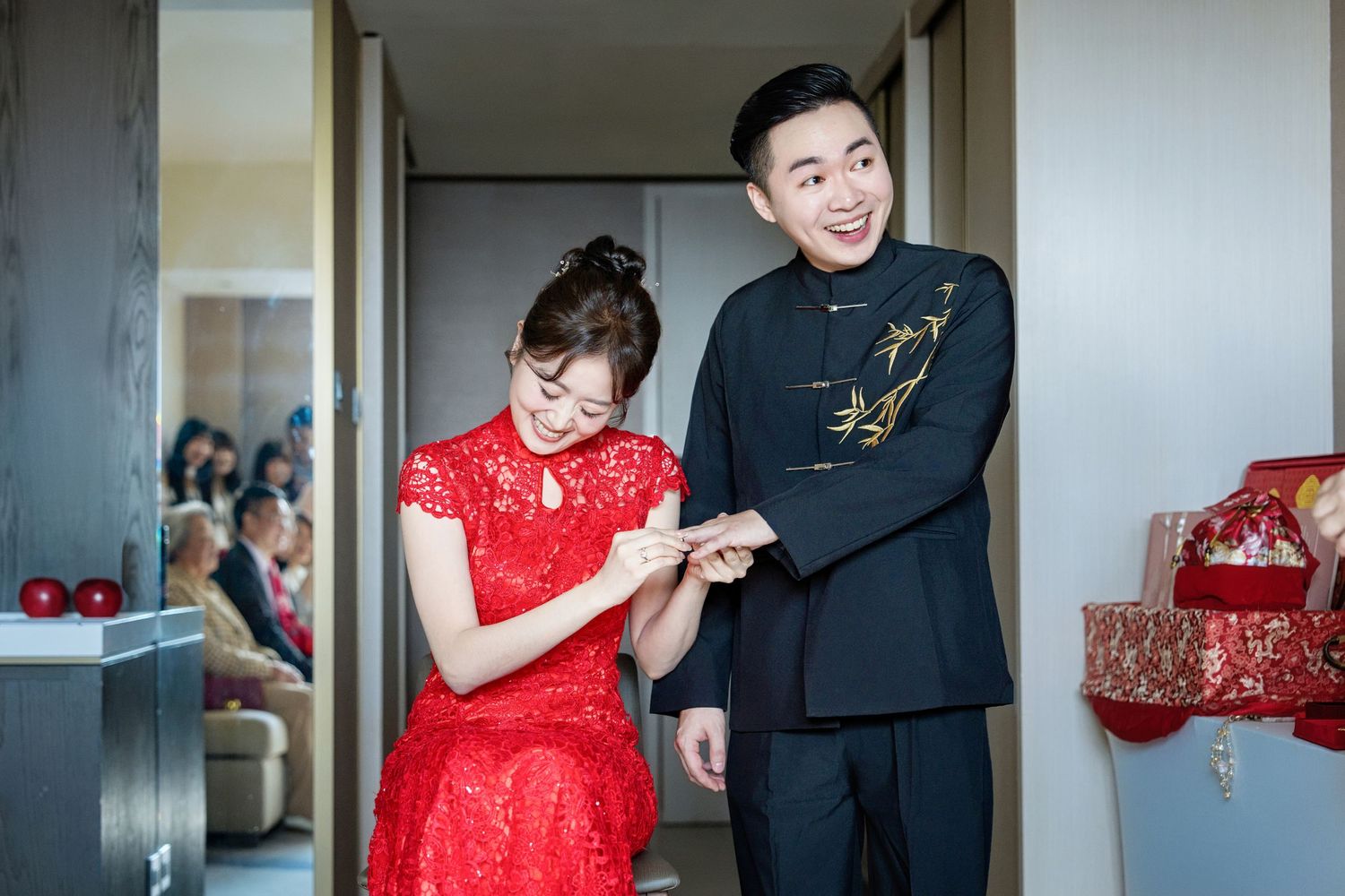 A couple in red and black formal attire dance together in a hallway sequence of photos.