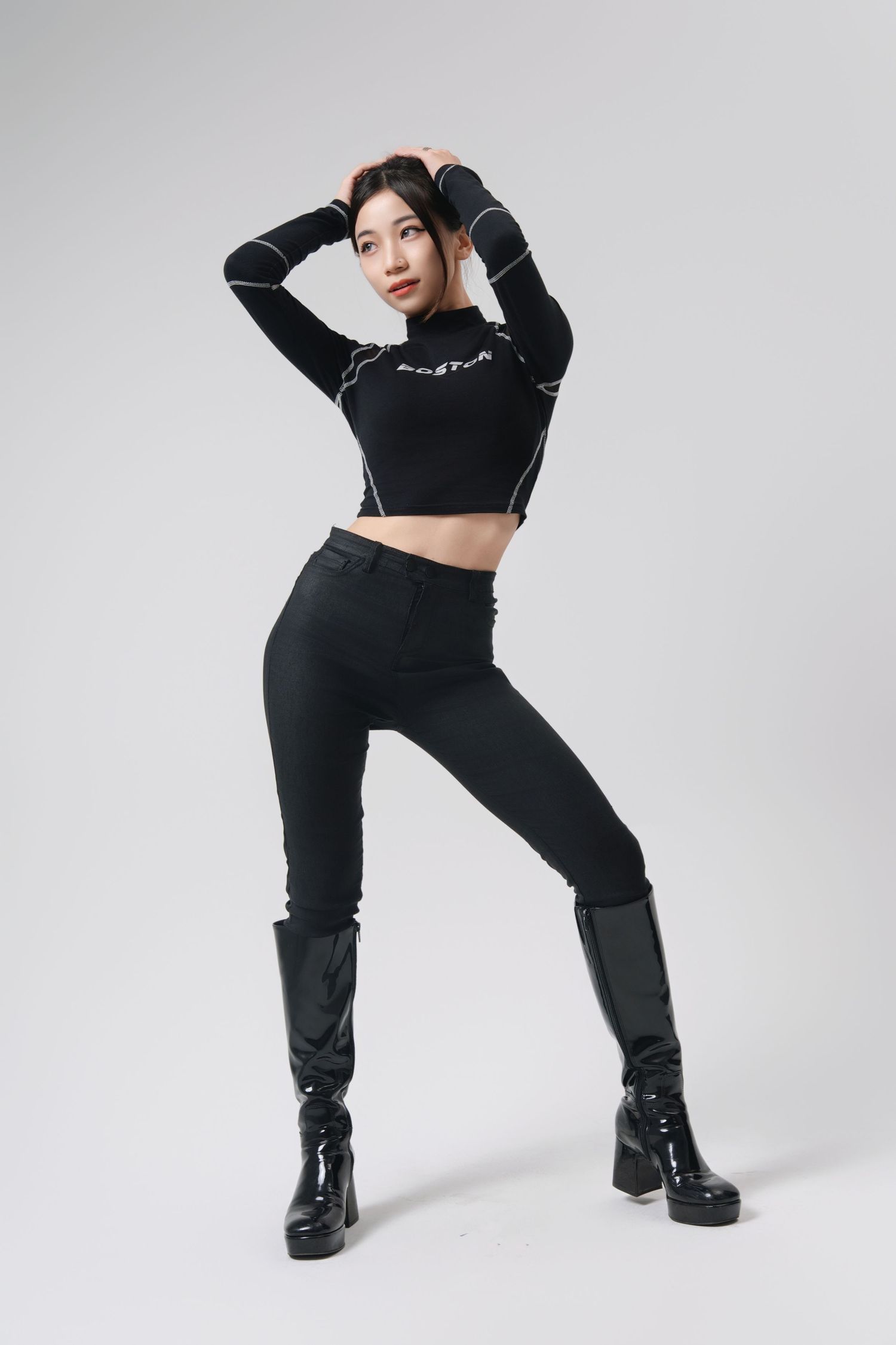 Athletic figure strikes dynamic dance-like poses wearing black activewear and chunky boots against white backdrop.