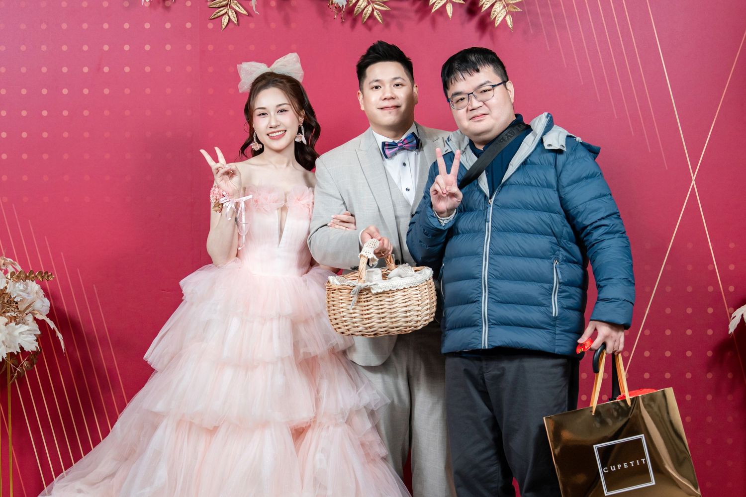 Family portrait session with pink backdrop and decorative elements in studio setting.