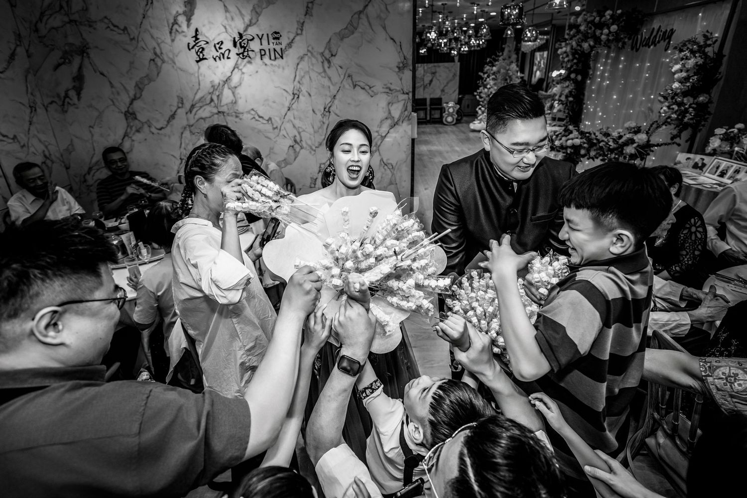 A sequence of black and white photos showing a group of people dancing and having fun at a lively party.