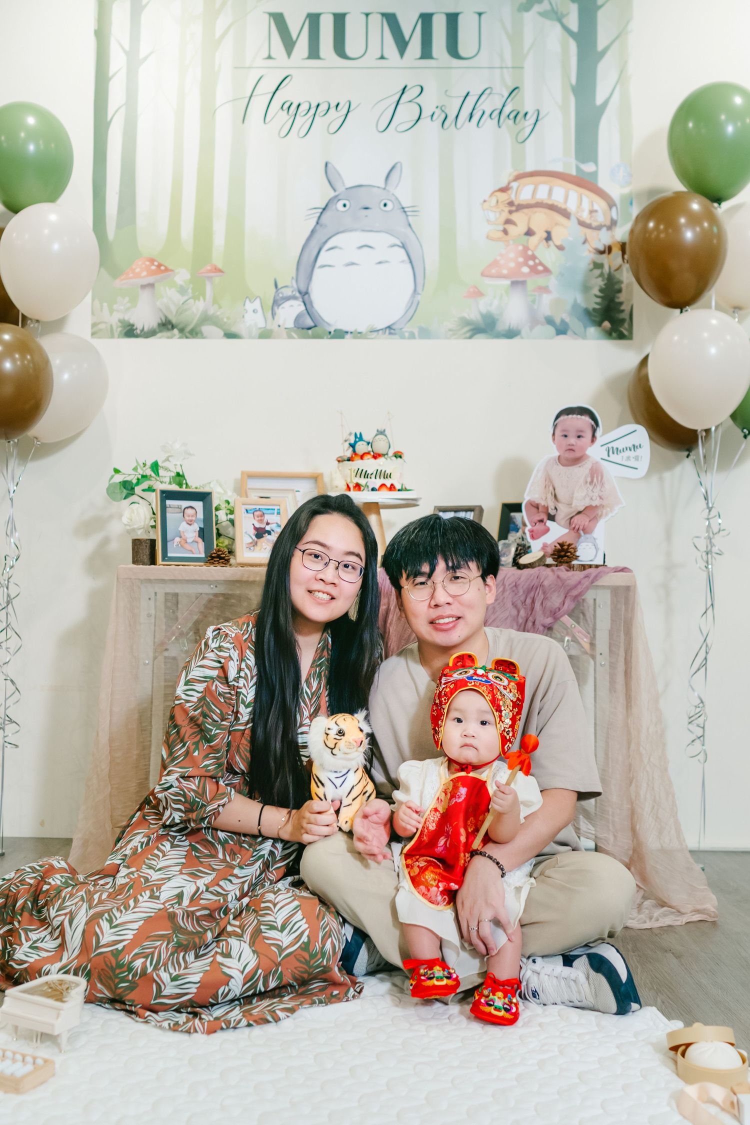 Totoro-themed birthday party setup with balloons and decorative backdrop for a baby celebration.