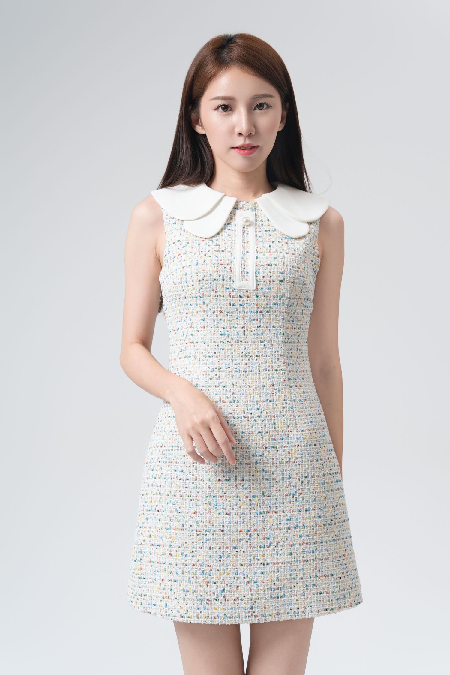 A sleeveless white dress with colorful polka dots and peter pan collar shown from multiple angles on a light background.