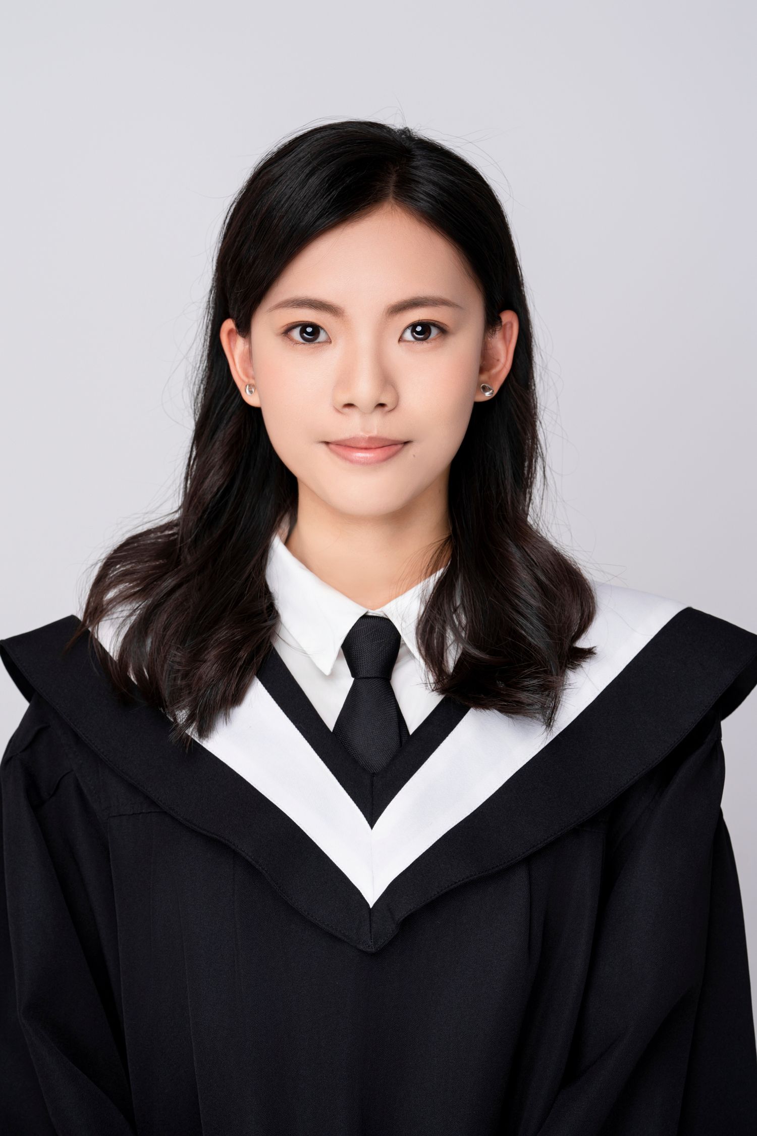 Professional headshot portrait series showing a person in a black suit and tie against a white background.