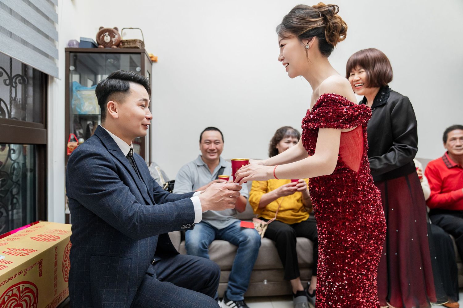 A sequence of candid moments at a gathering shows people interacting and sharing food in a casual indoor setting.