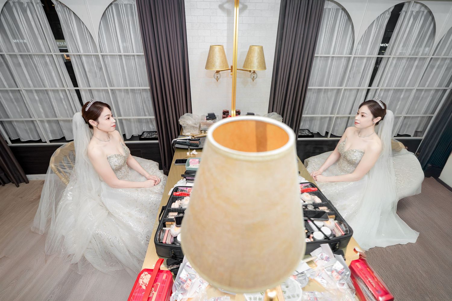 A sequence of bridal gown fitting photos showing dress alterations and measurements being taken in a modern studio.