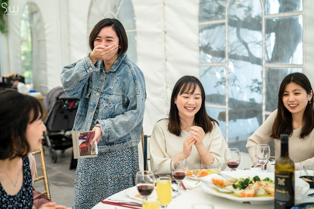 Guests enjoying a meal and conversation at an elegant indoor reception.