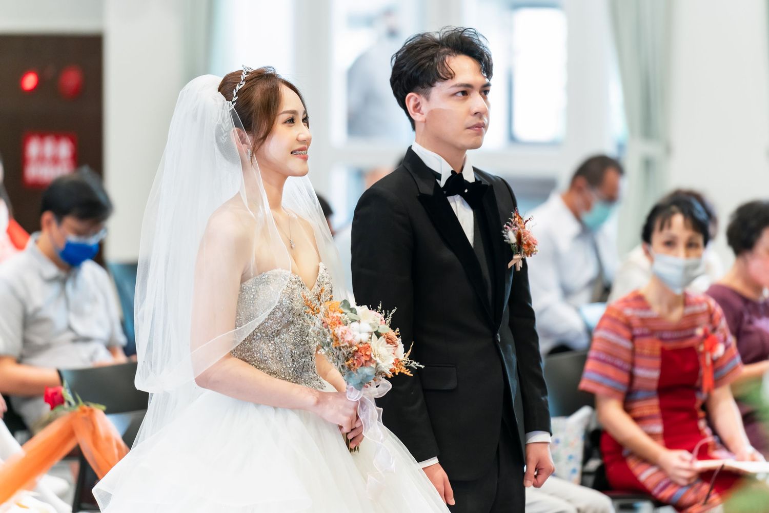 Elegant wedding ceremony with couple in formal attire standing together at the altar.