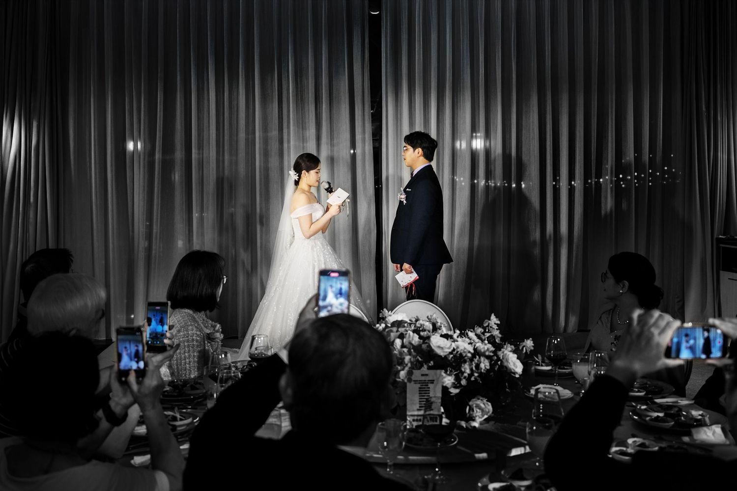 A black and white photo series showing a couple dancing during their first dance at a wedding reception.