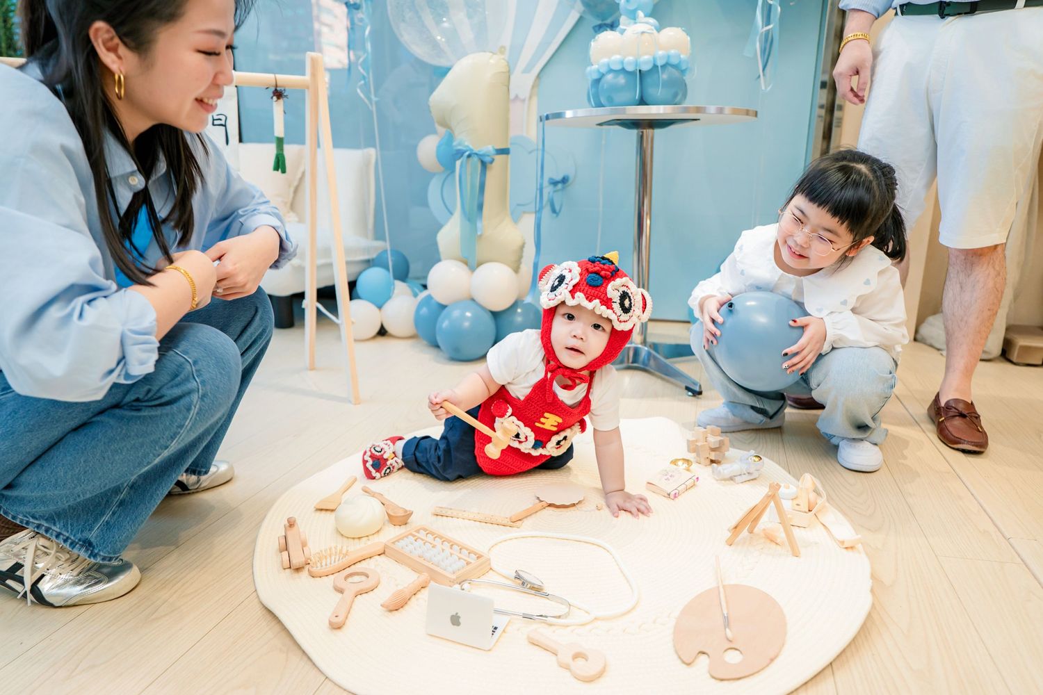 Medical staff in blue scrubs examine a baby during a routine pediatric checkup at a clinic.
