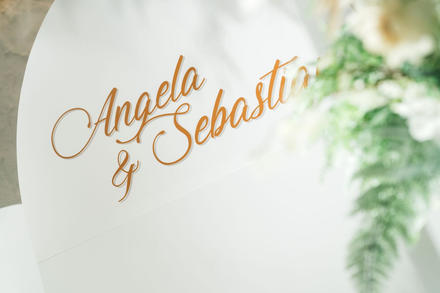 Elegant gold calligraphy text designs on white backgrounds showcase decorative lettering and artistic flourishes.