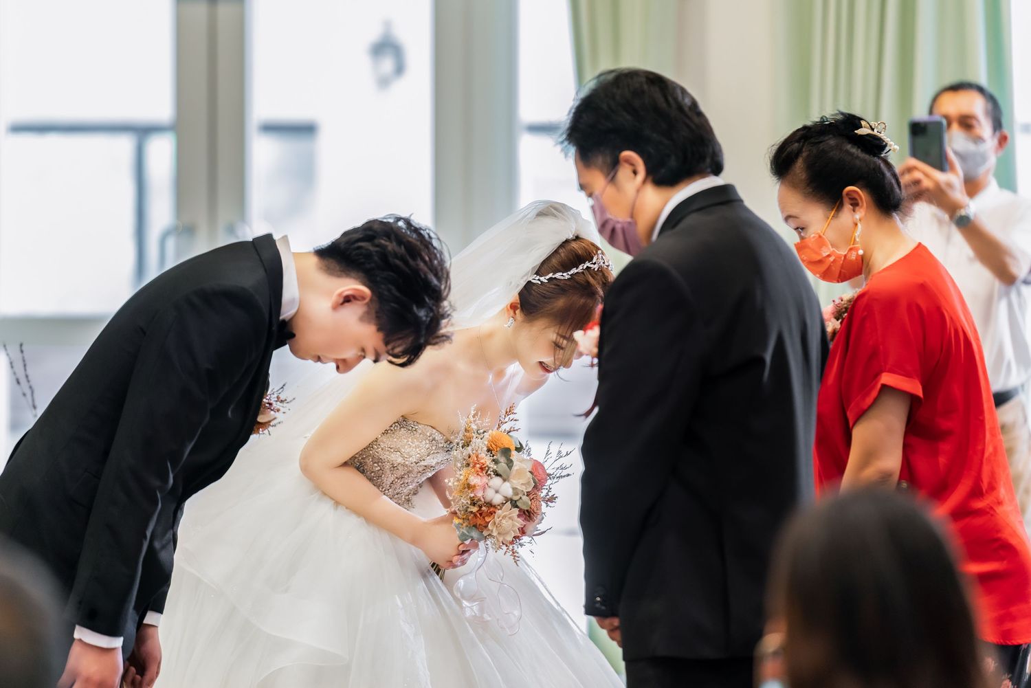 Traditional wedding ceremony with couple bowing during formal rituals.