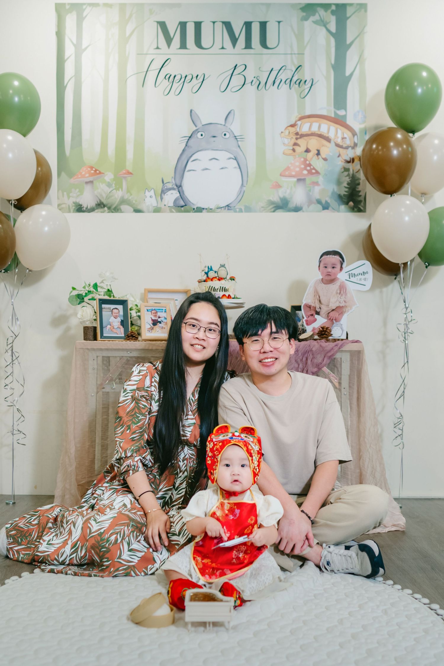 A family portrait set showing casual moments with green and silver balloons against a dreamy forest-themed backdrop.