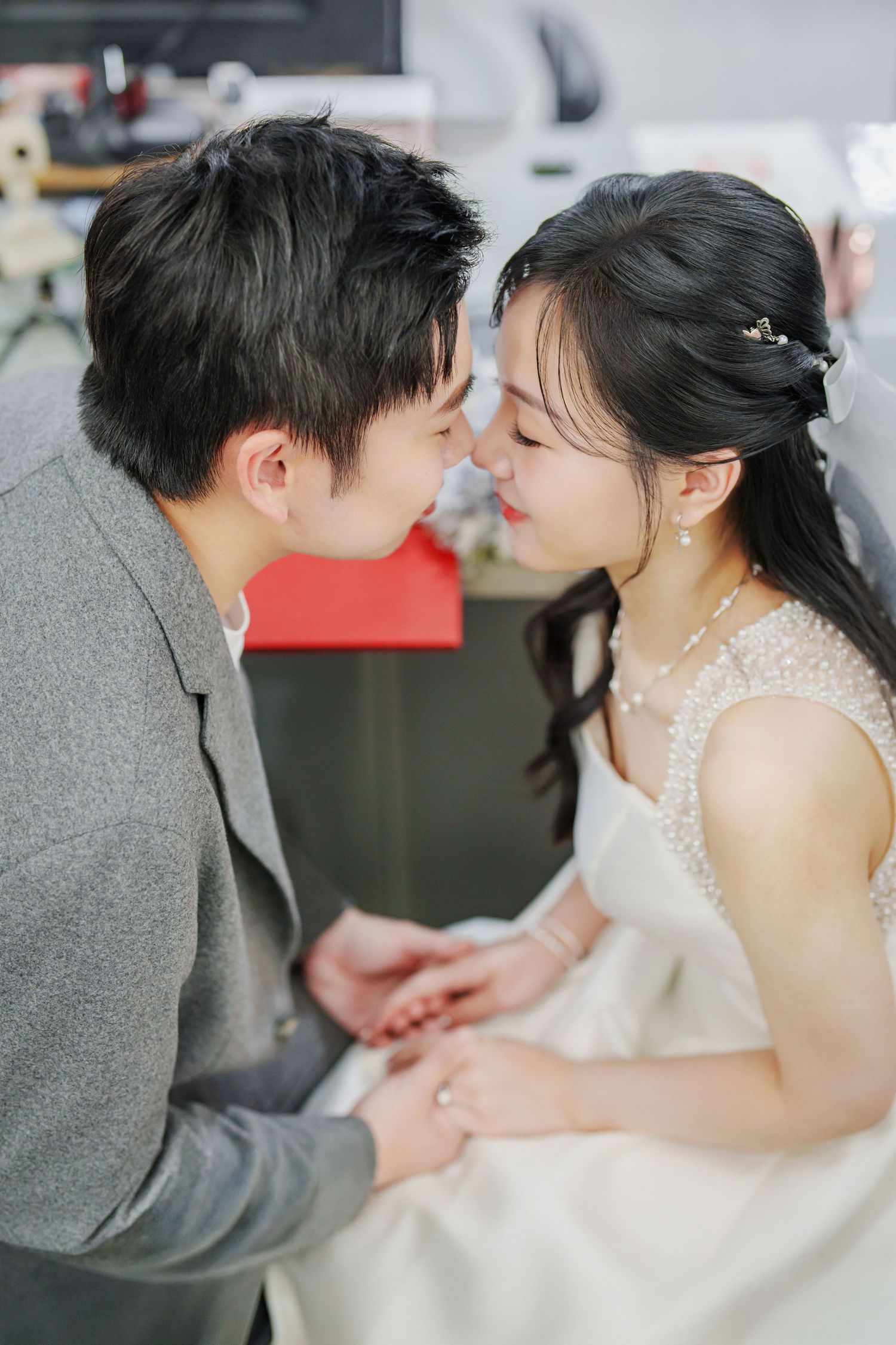 A romantic wedding couple shares tender kisses in a sequence of elegant portrait photos.