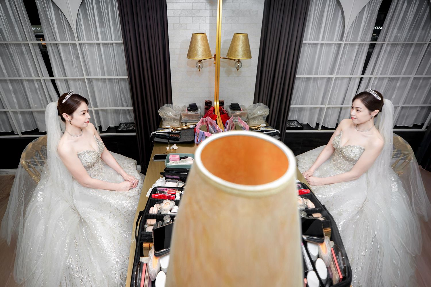 A sequence of photos showing a person in a white wedding dress being fitted and adjusted during a bridal fitting session.