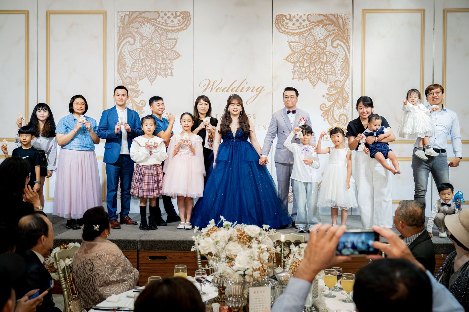 A sequence of wedding reception photos showing guests reacting and celebrating during emotional moments at a banquet hall.