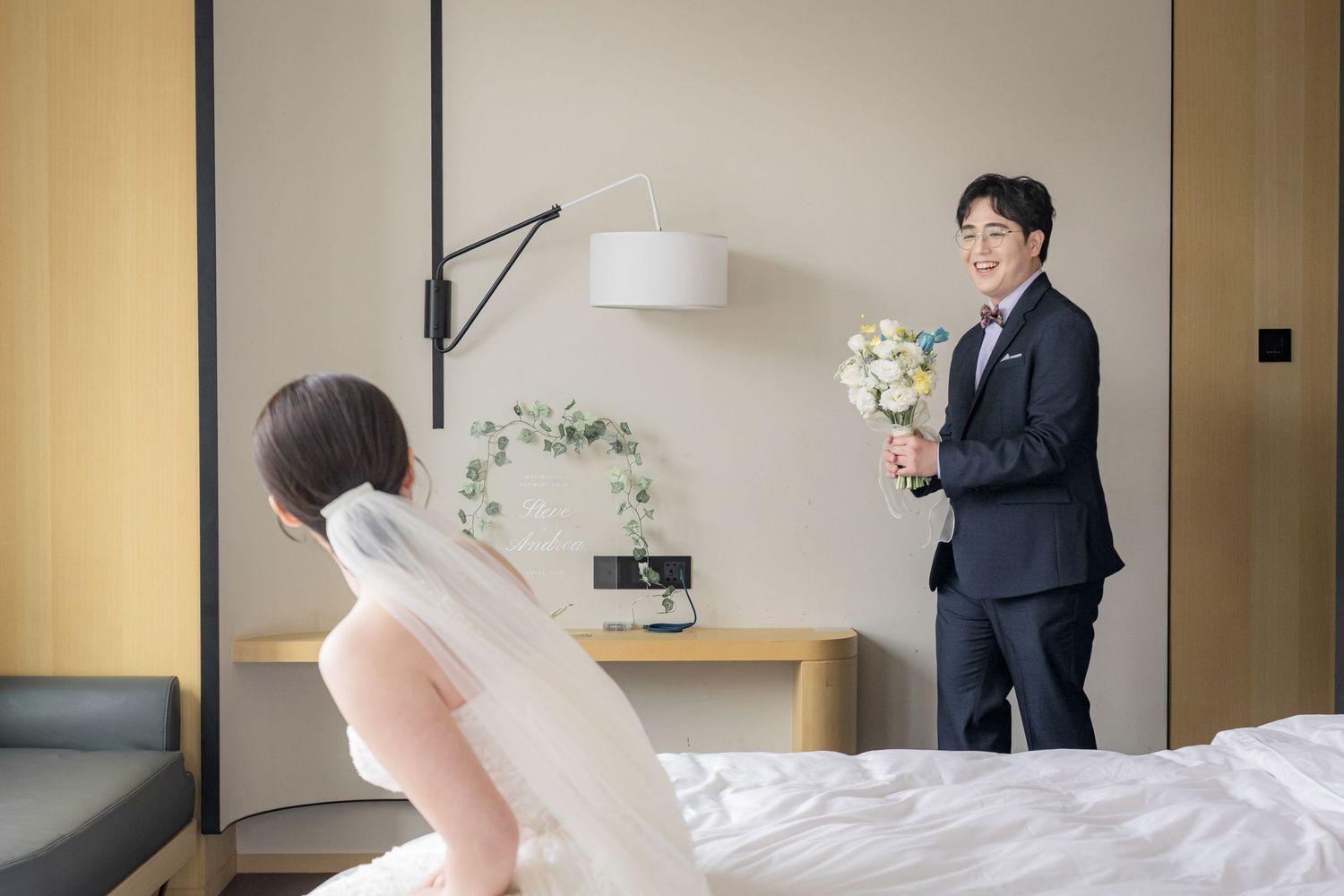 Wedding preparation scene in a modern hotel room with window light.