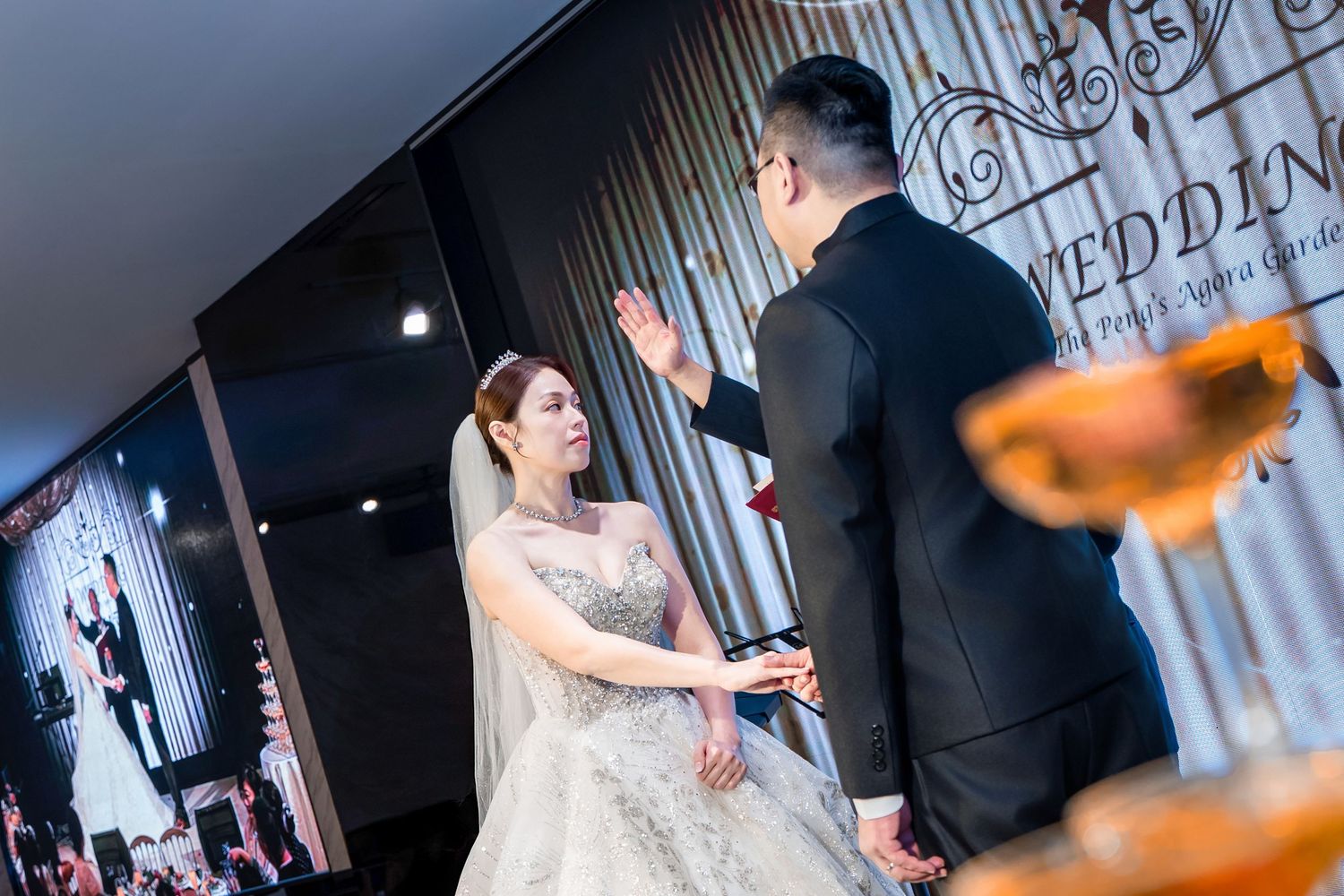 A wedding celebration sequence showing elegant reception moments with dancing and candid interactions in a dimly lit venue.