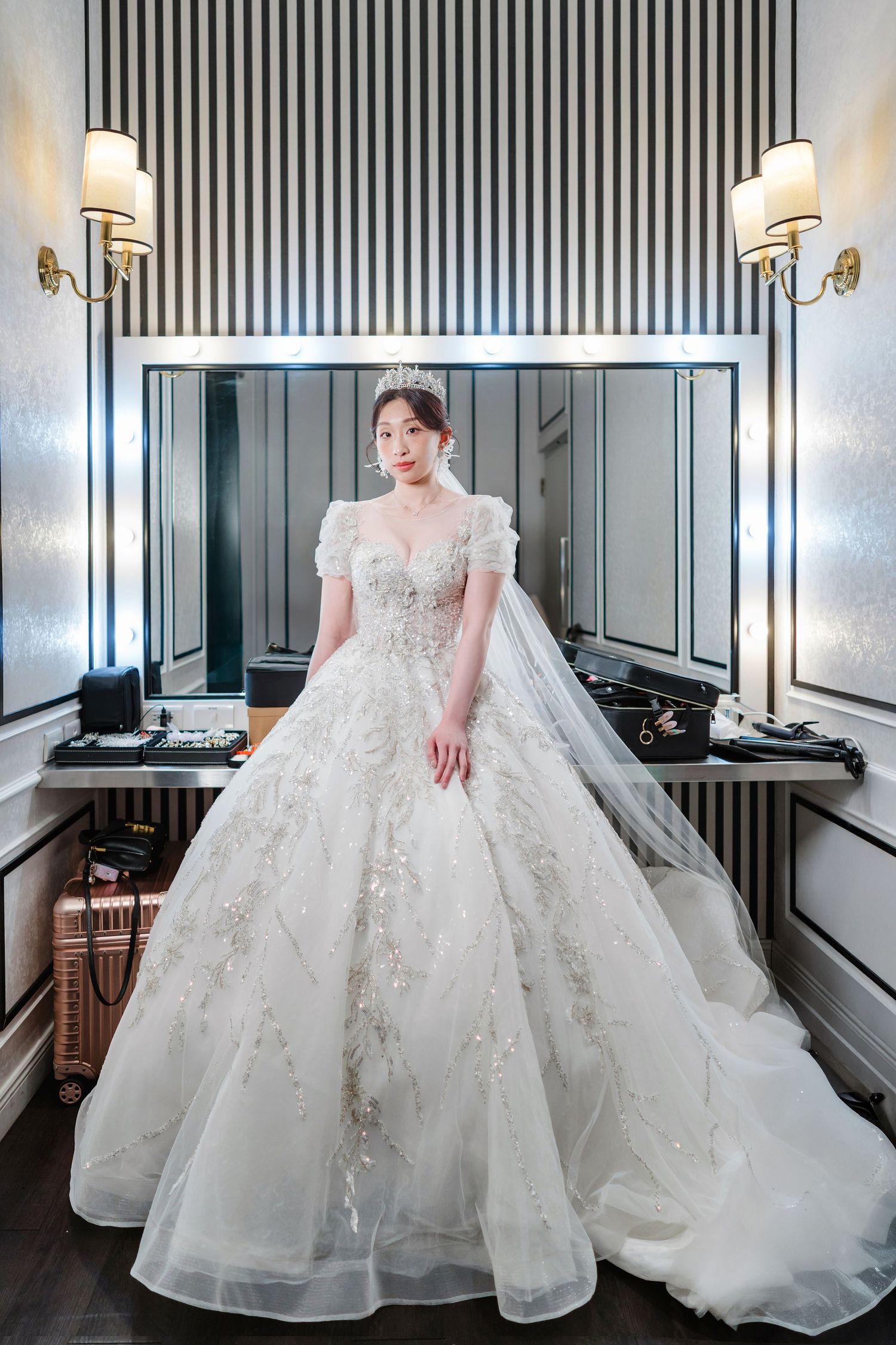 Elegant ball gown wedding dress with intricate beading and lace details features puff sleeves and sweetheart neckline in modern room.