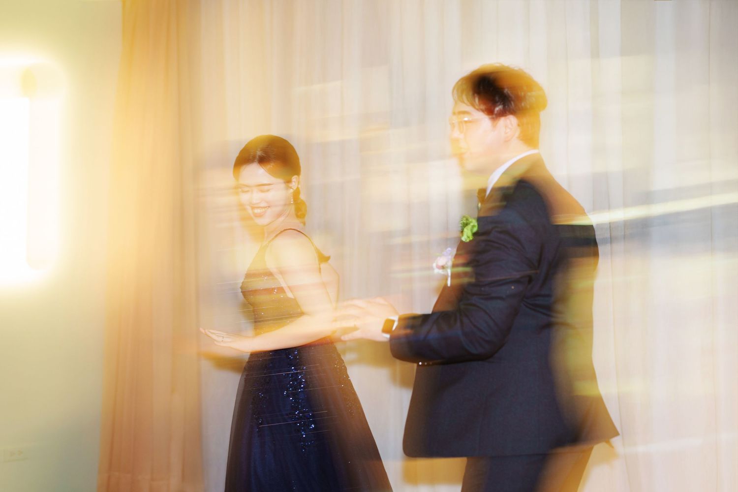 A couple dancing together at an elegant event, captured with a soft focus dreamy effect creating a romantic atmosphere.