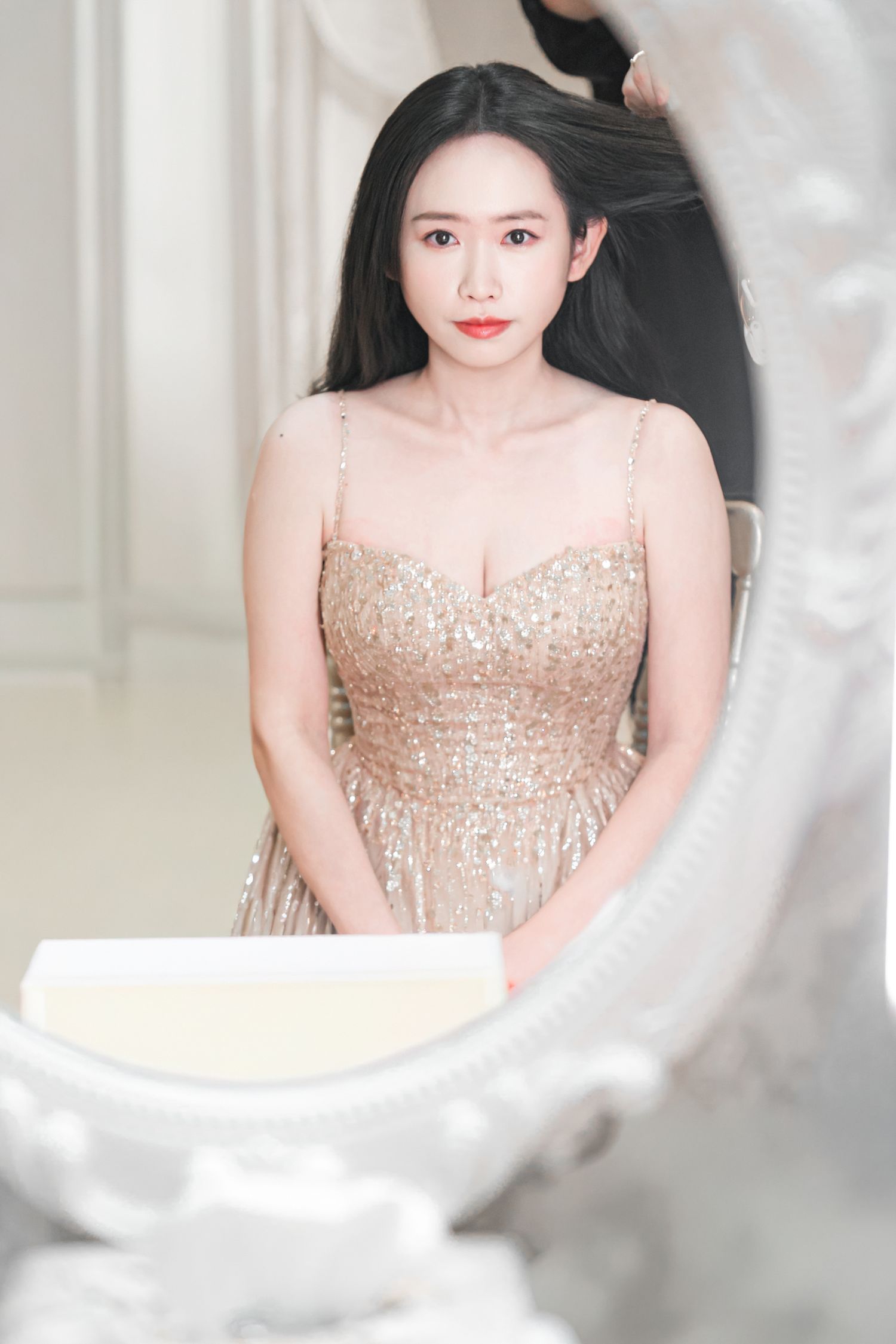 A series of elegant portraits showing a person in a sparkling beige gown framed by ornate white decor.
