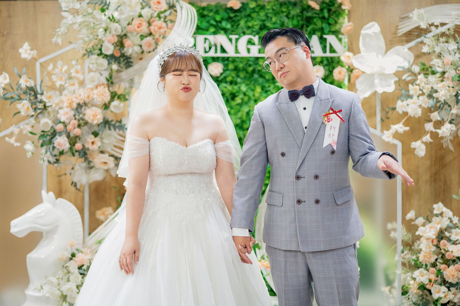 An elegant outdoor wedding ceremony setup with blush floral decorations and a wooden arch structure.