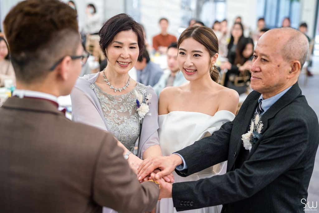 Wedding ceremony showing traditional family greeting and well-wishes.